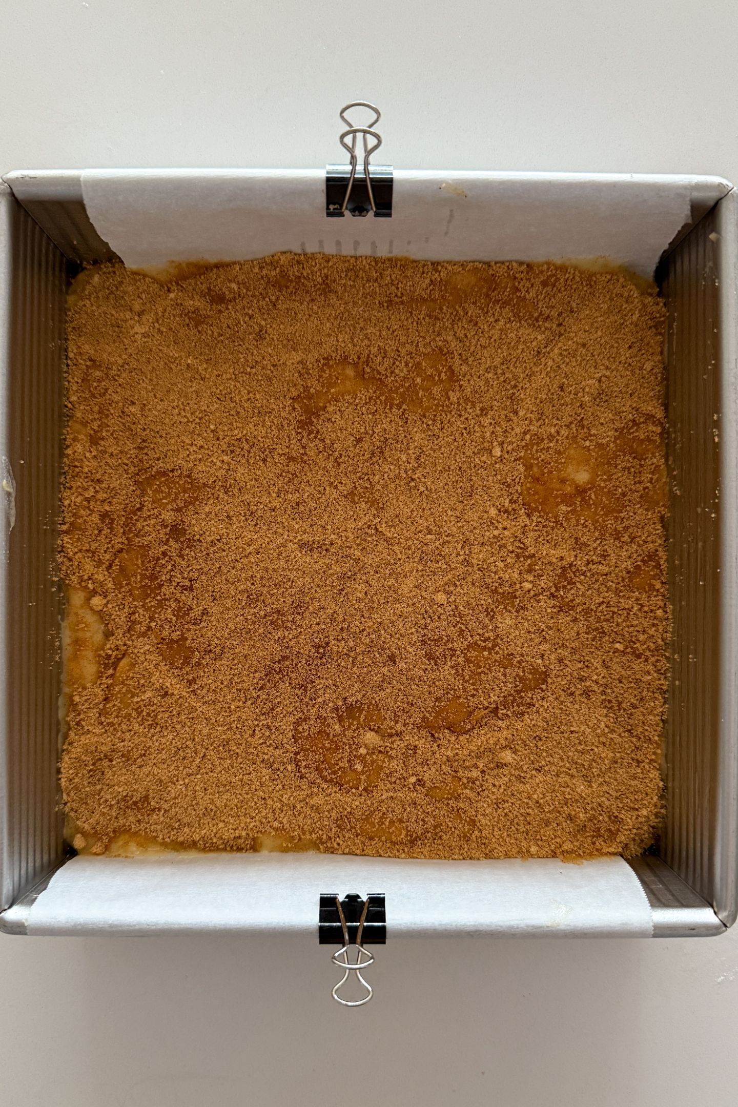 Cinnamon sugar layer sprinkled over the batter in the pan.