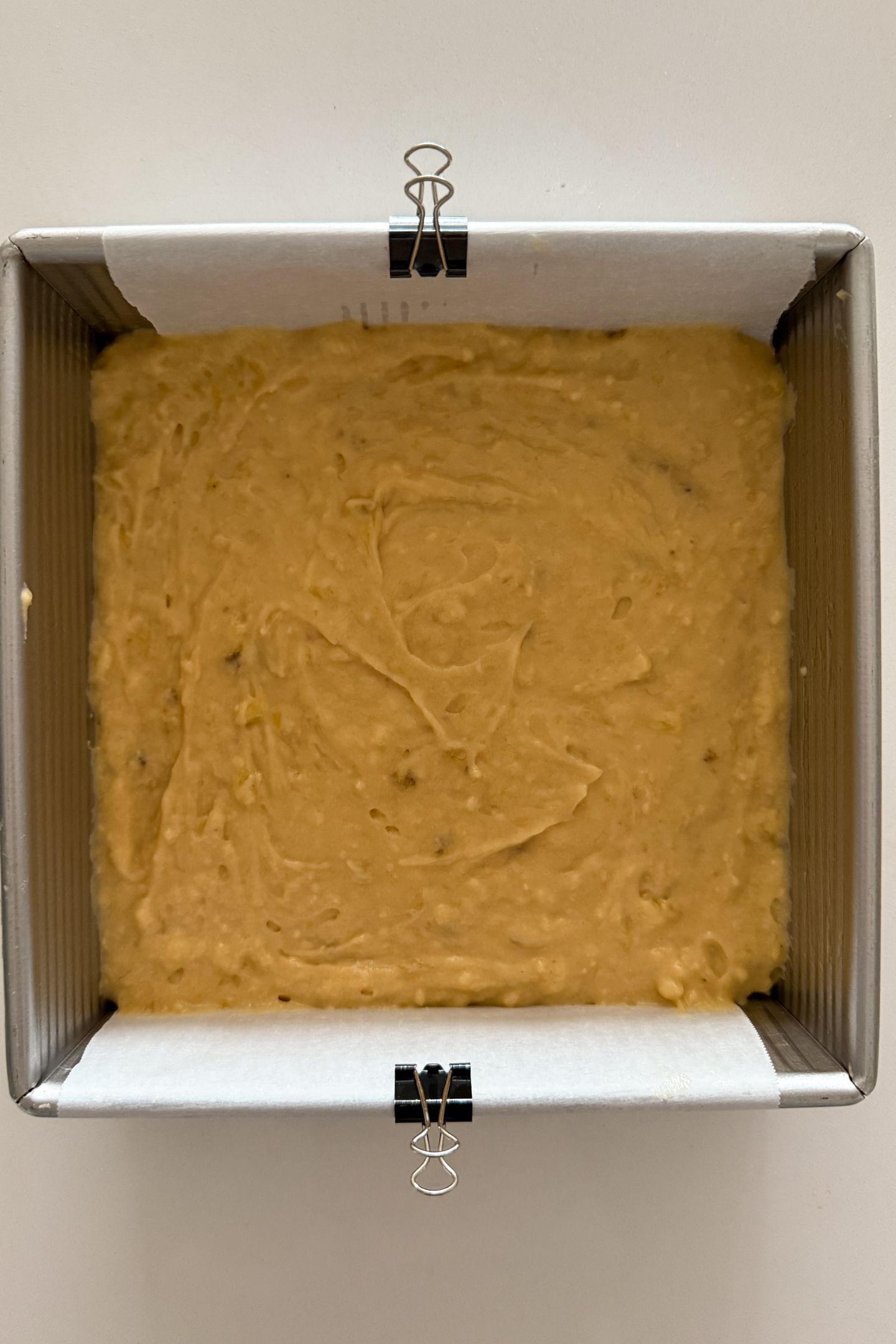 Banana bread coffee cake batter transferred to a prepared pan.