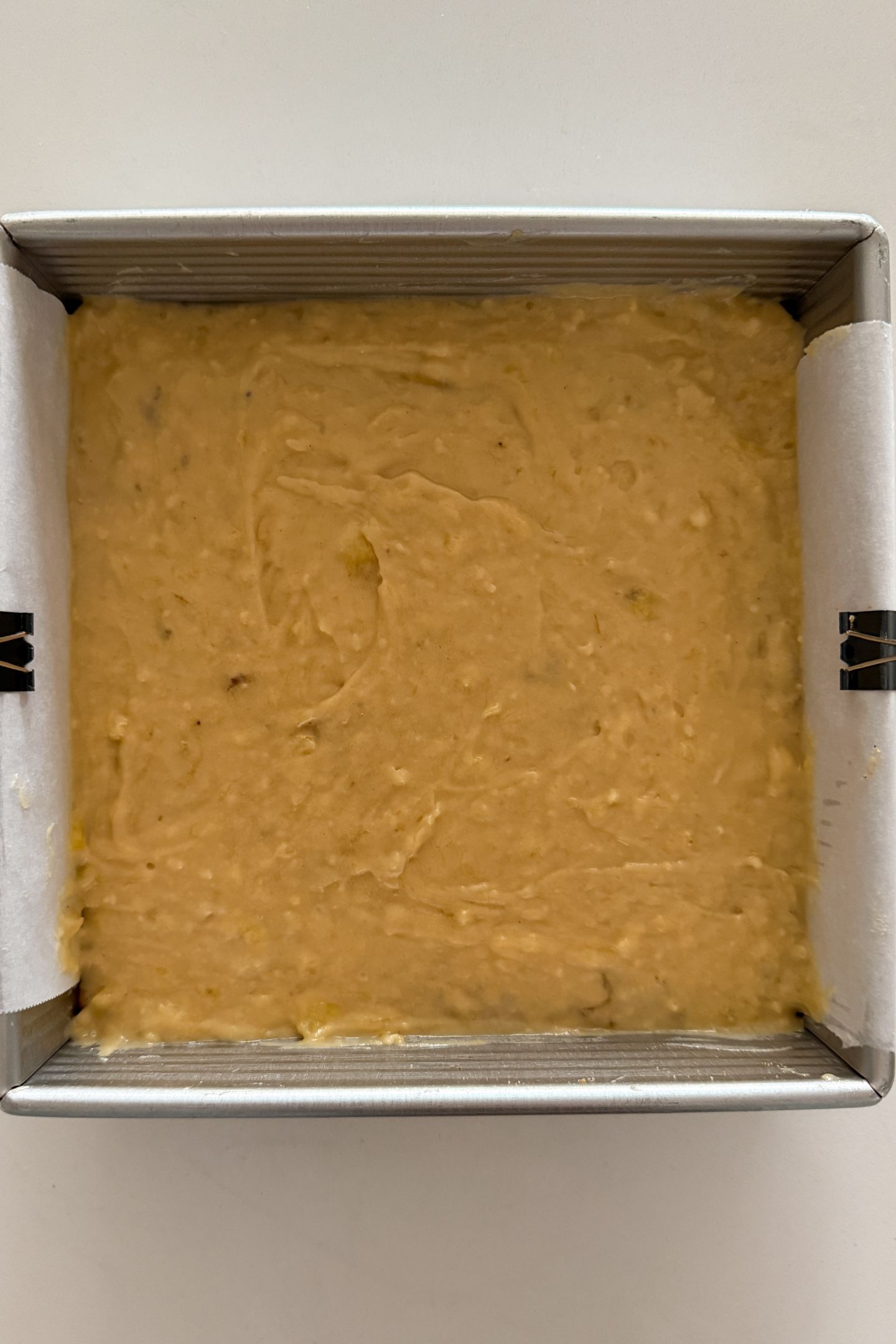 Spreading the remaining batter on top of the cinnamon sugar layer.