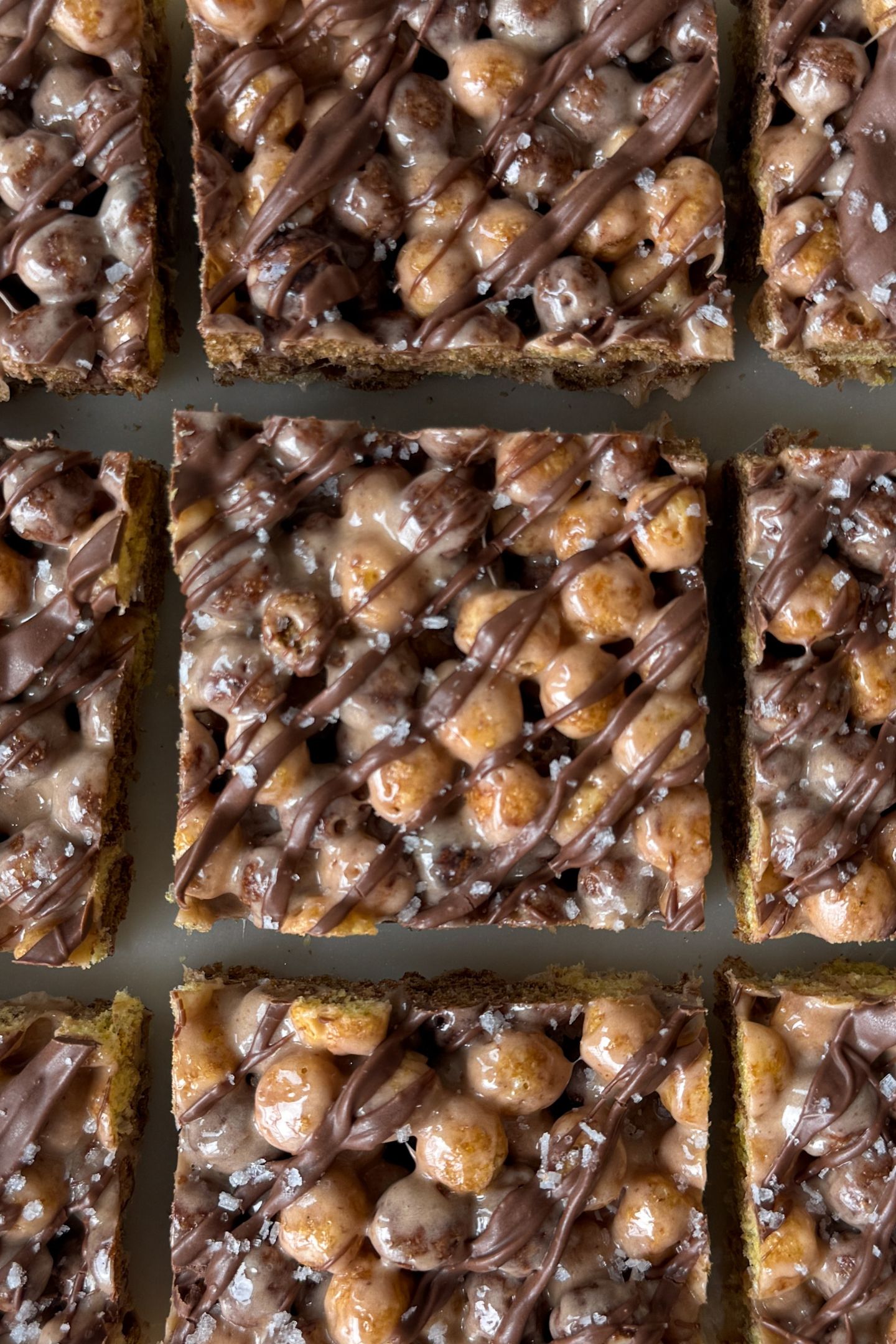 Sliced peanut butter chocolate krispie treats on a plate.
