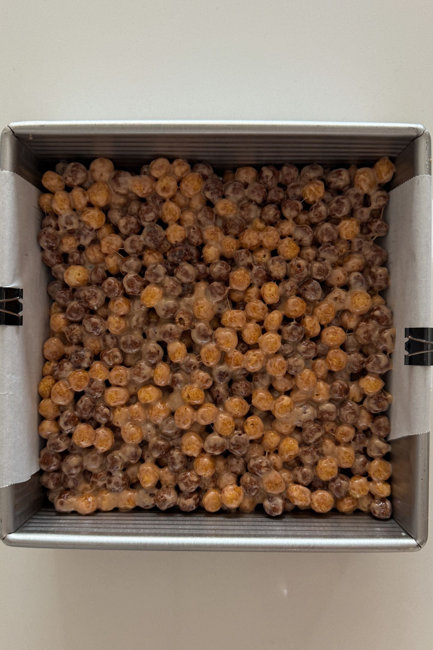 Spreading the mixture in an even layer in the pan.