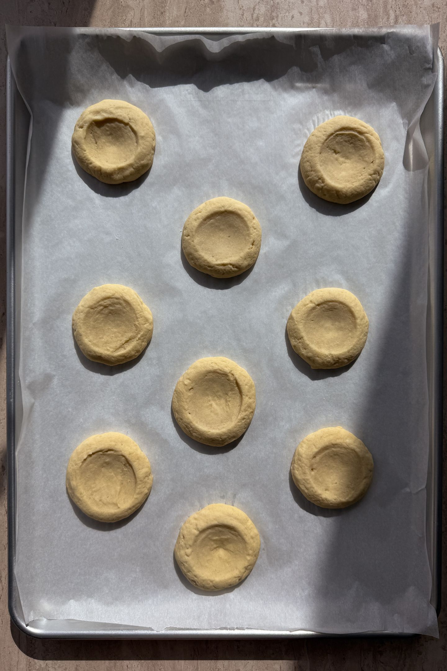A tray of baked cookies on parchment paper.