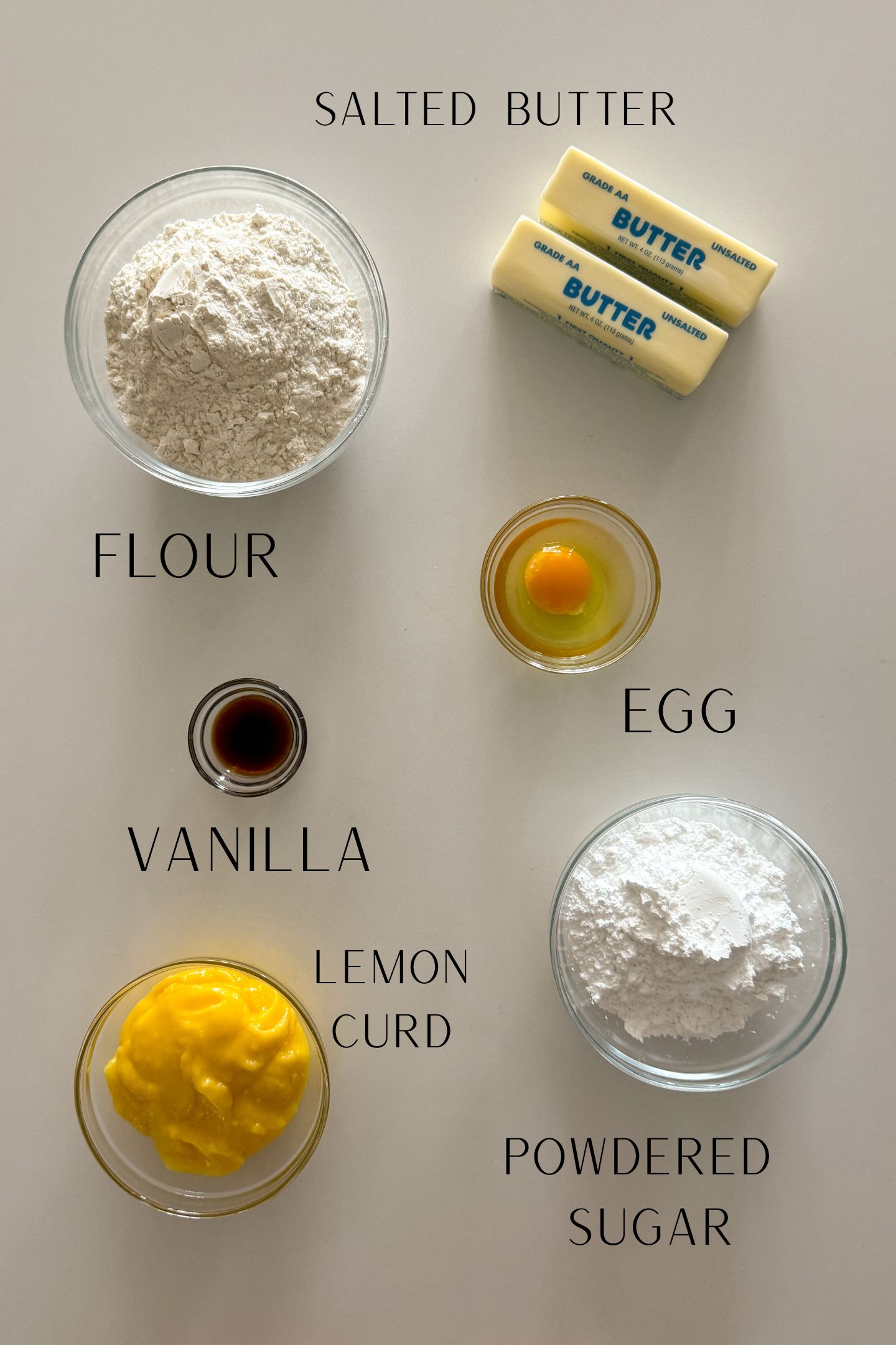 Ingredients measured out in bowls to make the buttery cookies with a homemade lemon curd.