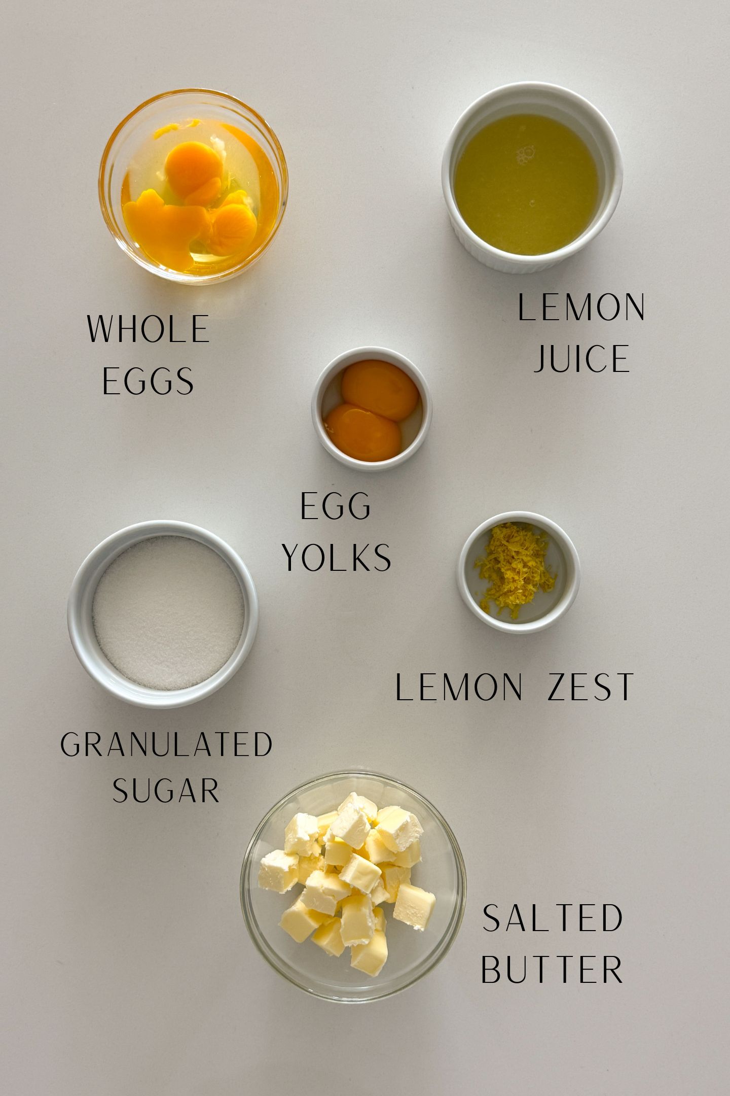 Ingredients measured out in bowls to make the lemon curd.