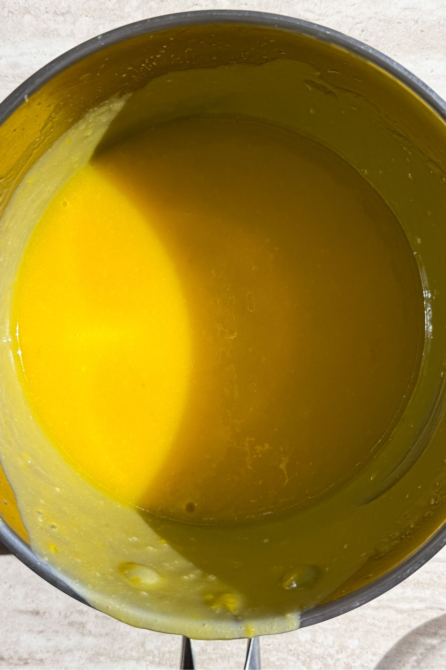 Lemon curd in a saucepan.