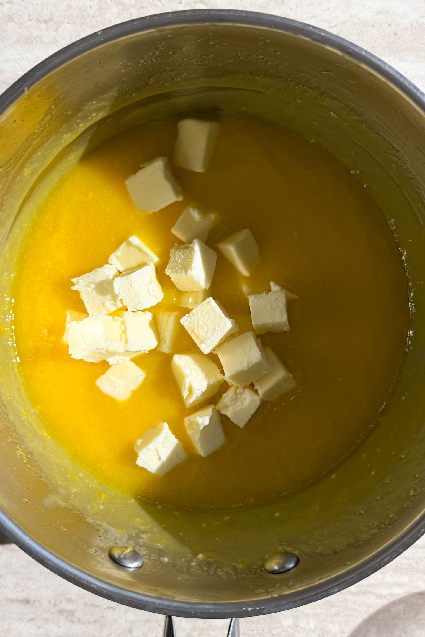 Adding butter to the lemon curd.