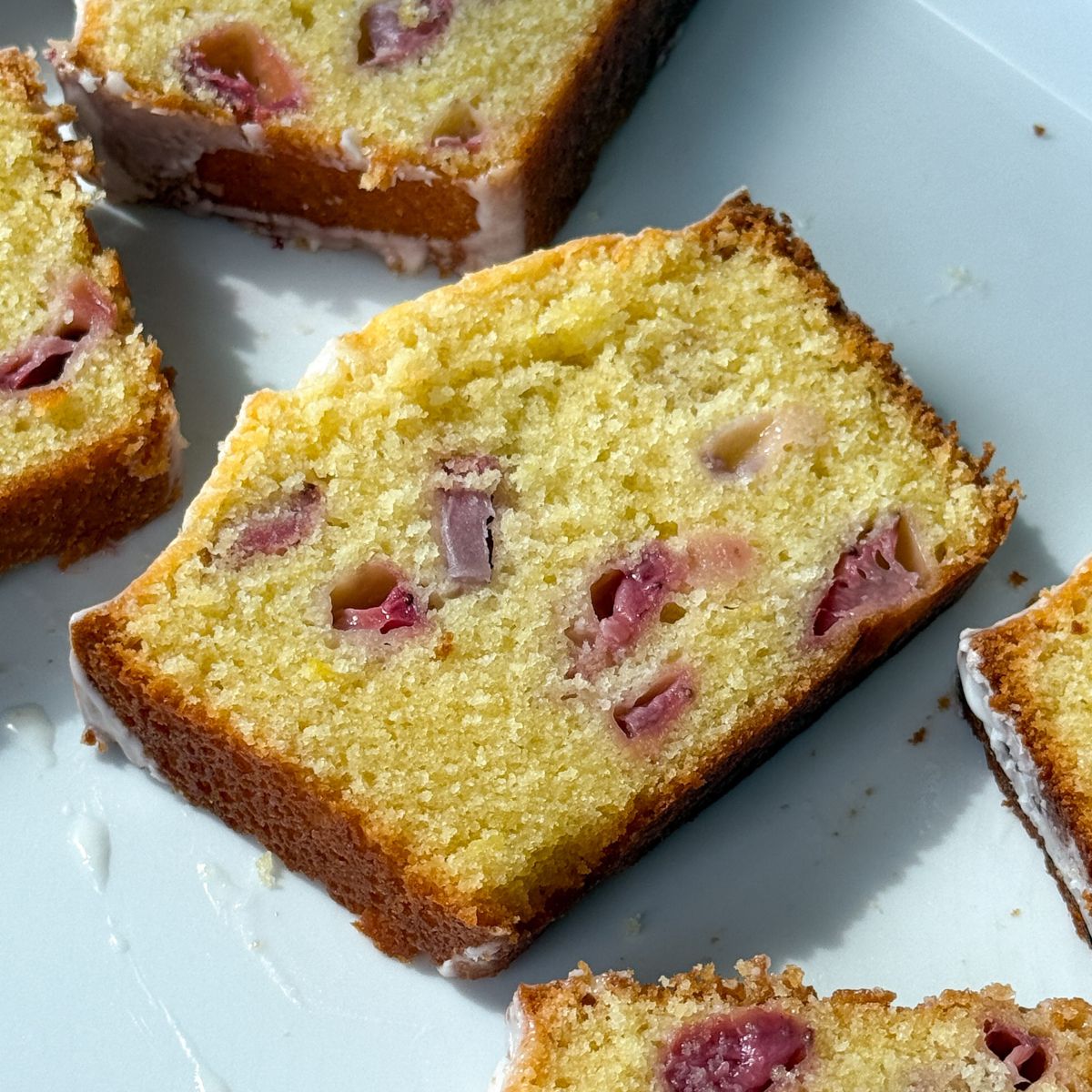 Slices of Strawberry Lemon Pound Cake on a serving platter.