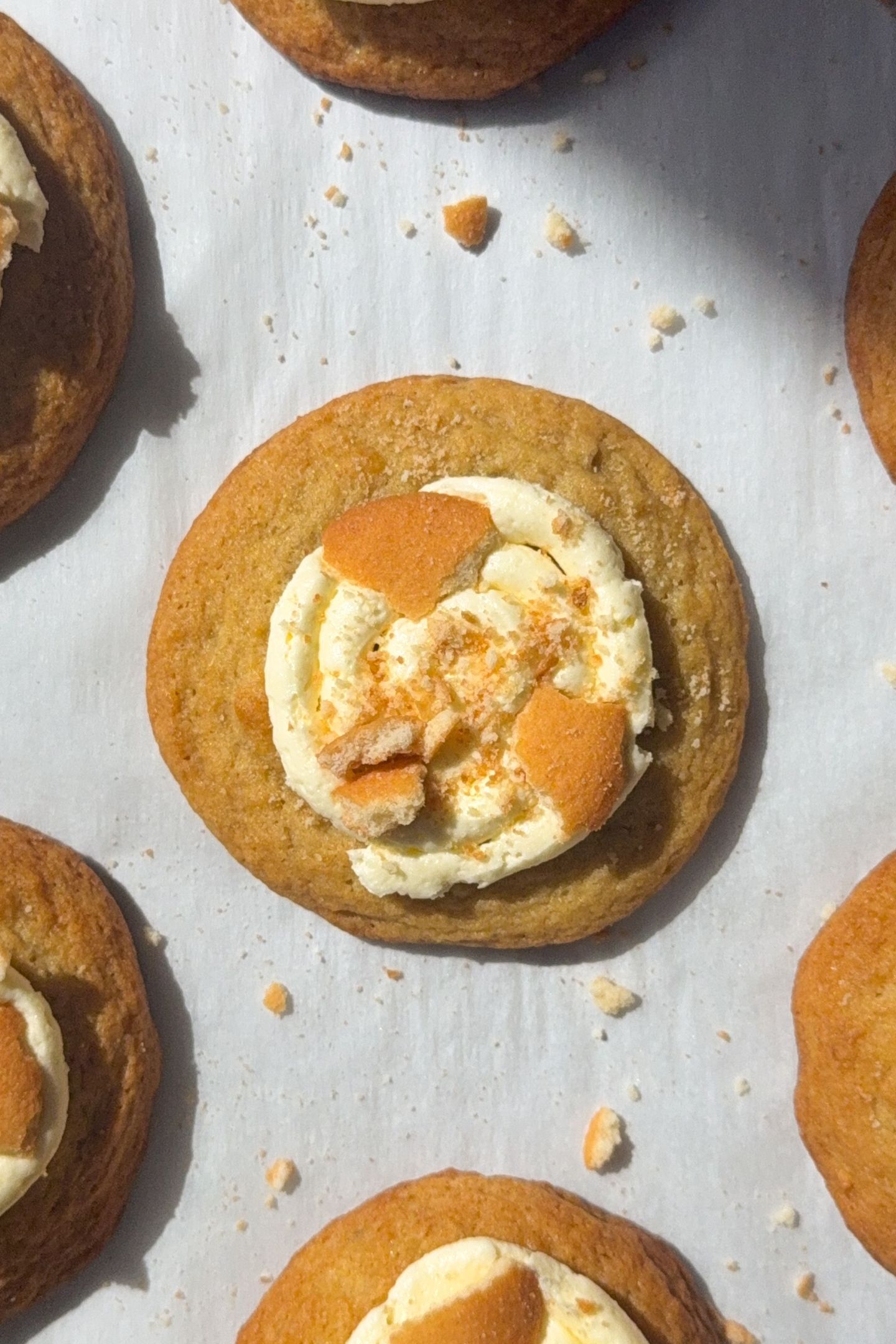 Banana pudding cookies topped with banana frosting and crushed vanilla cookie wafers.