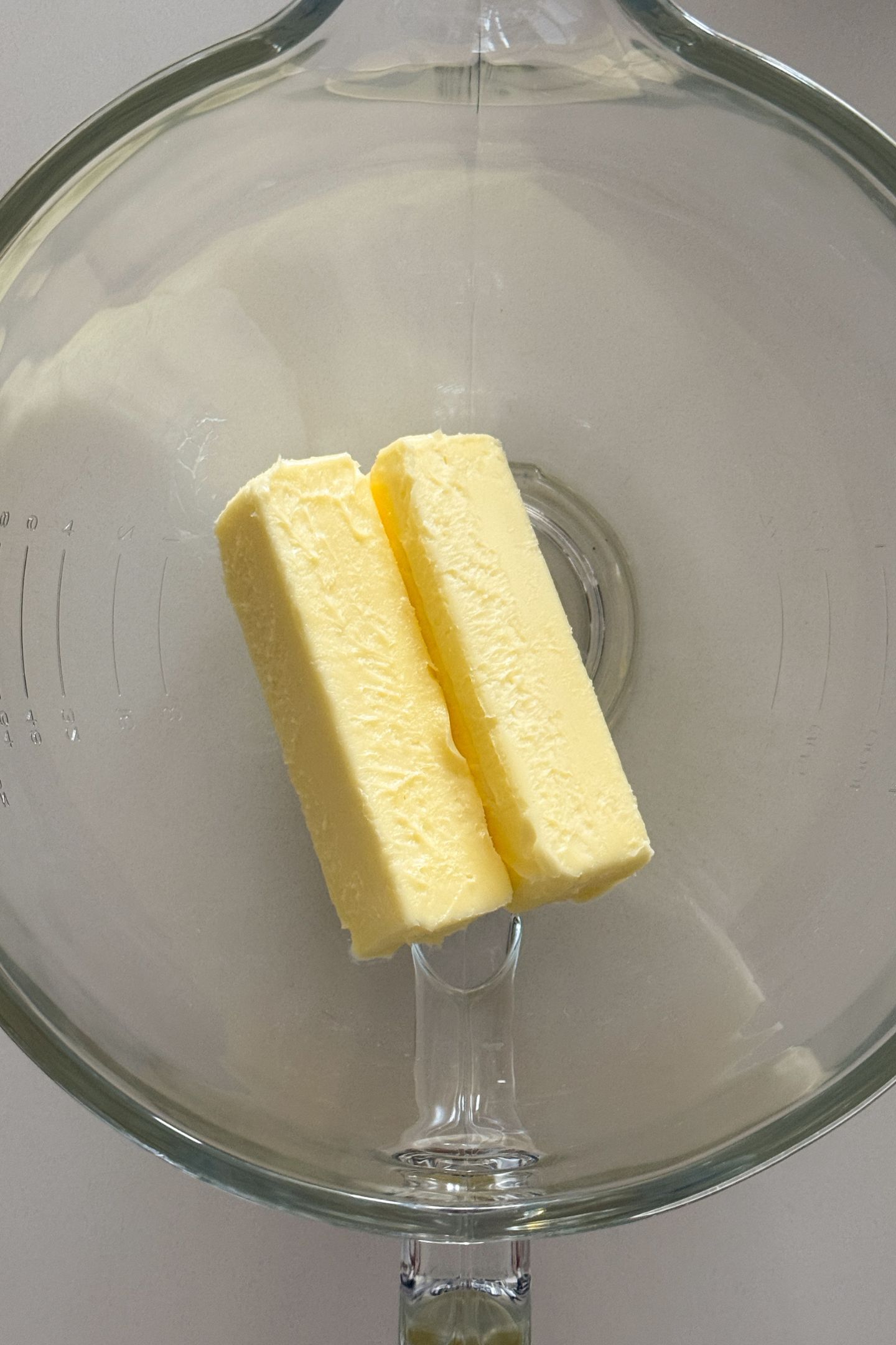 Softened butter in a stand mixer bowl.