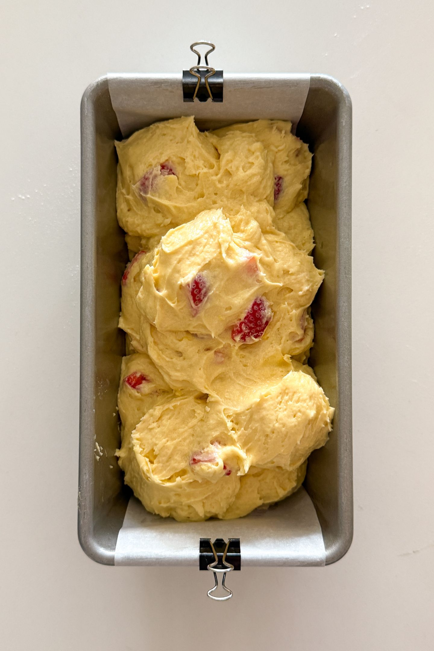 Transferring the batter to a prepared loaf pan.