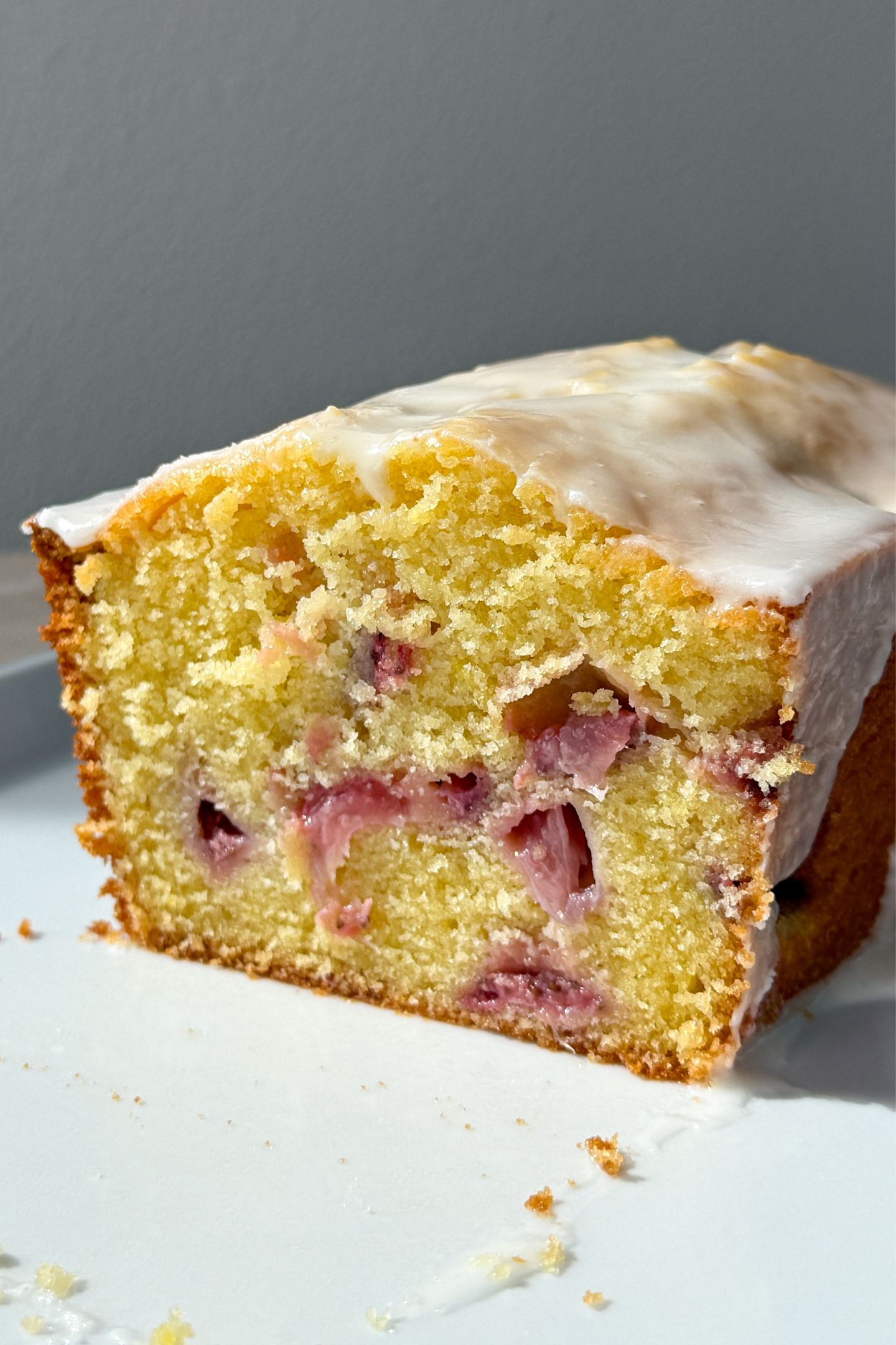 Sliced Strawberry Lemon Pound Cake showing the chunks of strawberries in the loaf.