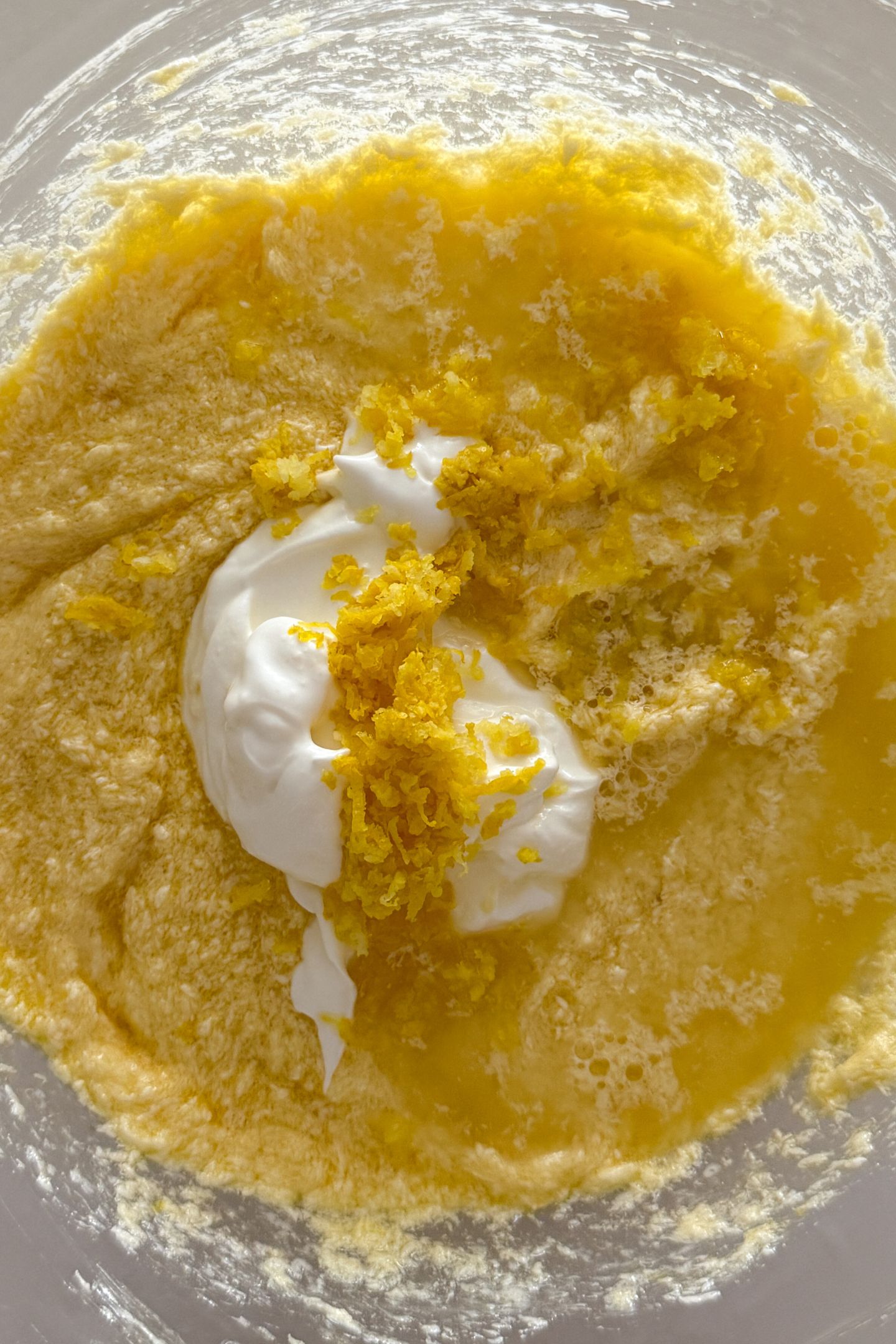 Adding lemon juice, lemon zest and sour cream to the wet ingredients.