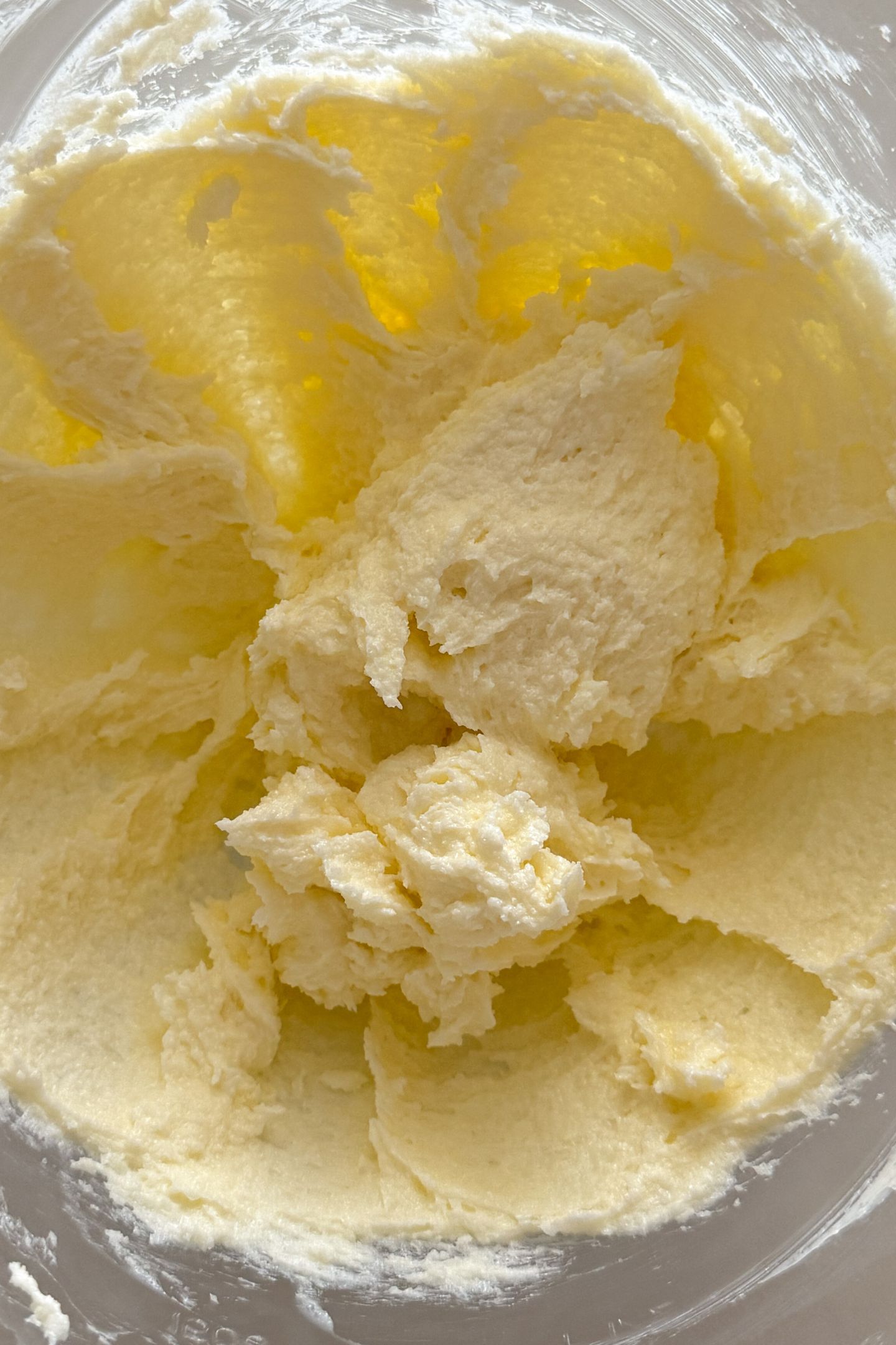 Softened butter and granulated sugar combined in a bowl.