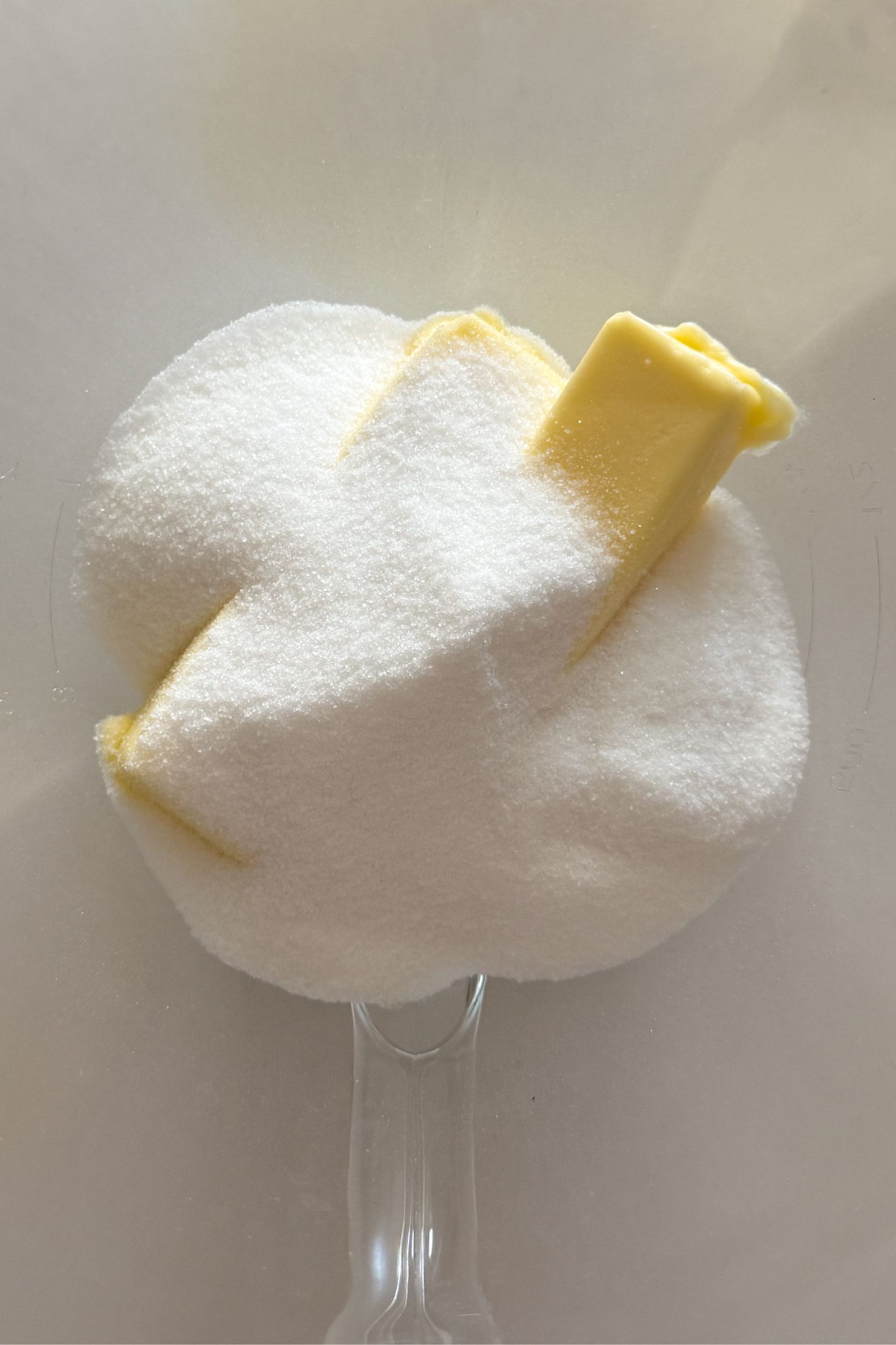 Softened butter and granulated sugar in a bowl.