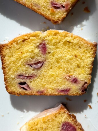 A slice of lemon strawberry pound cake on a serving dish.