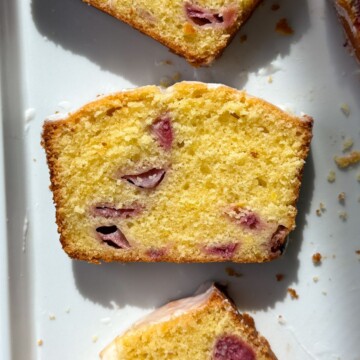 A slice of lemon strawberry pound cake on a serving dish.