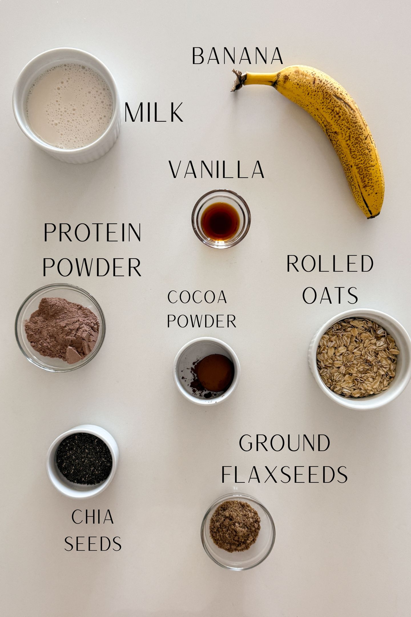 Ingredients measured out in bowls to make the chocolate banana overnight oatmeal.