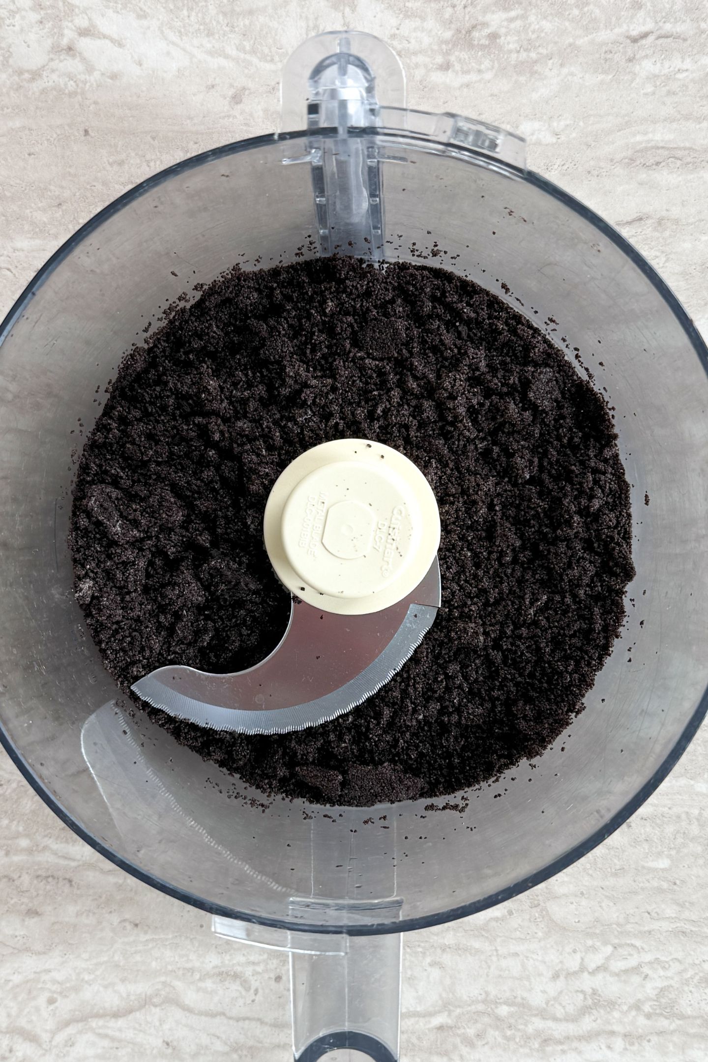 Crushed oreo cookies in a food processor.