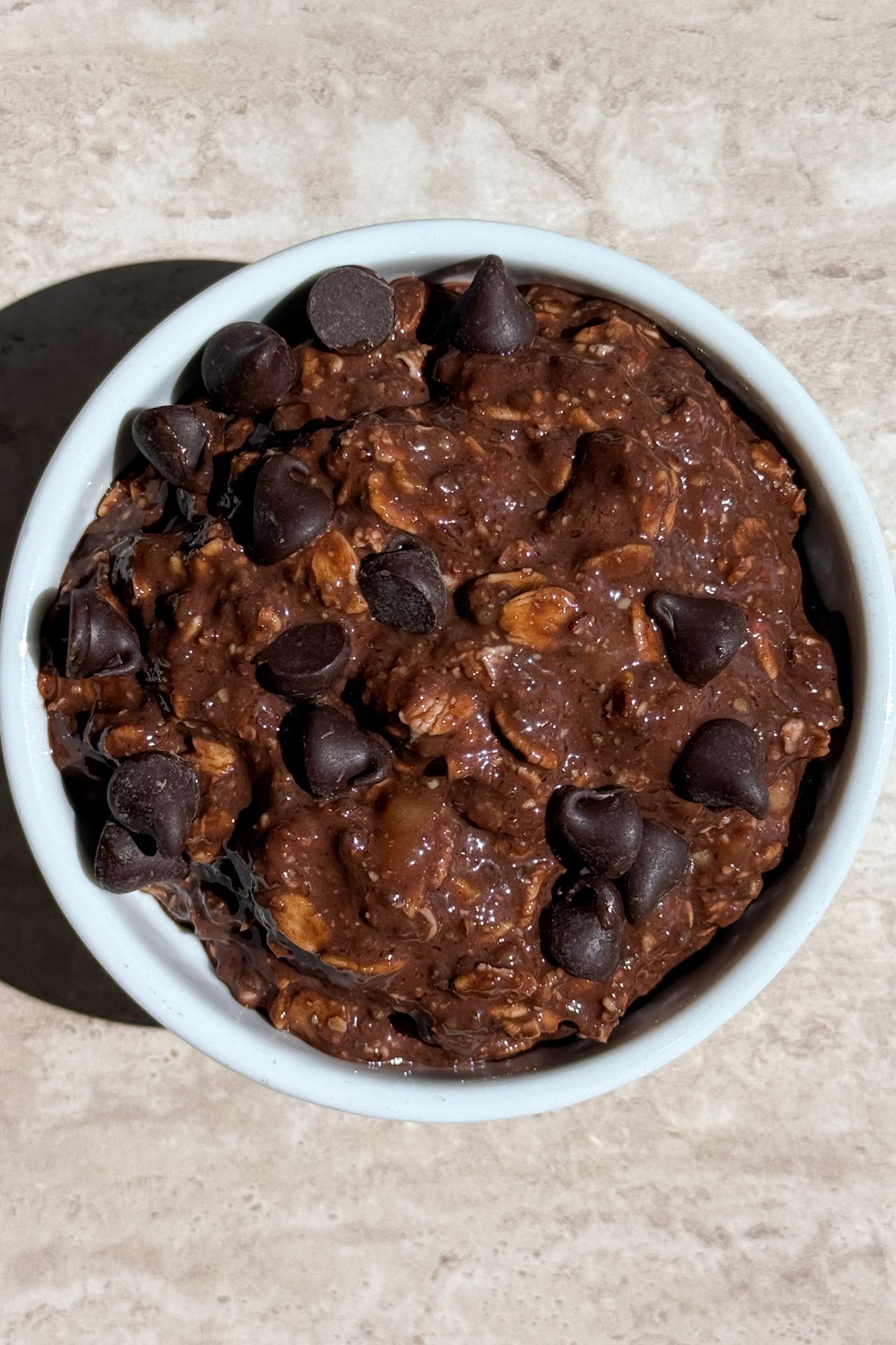 Overnight oats transfer to a bowl and topped with chocolate chips.