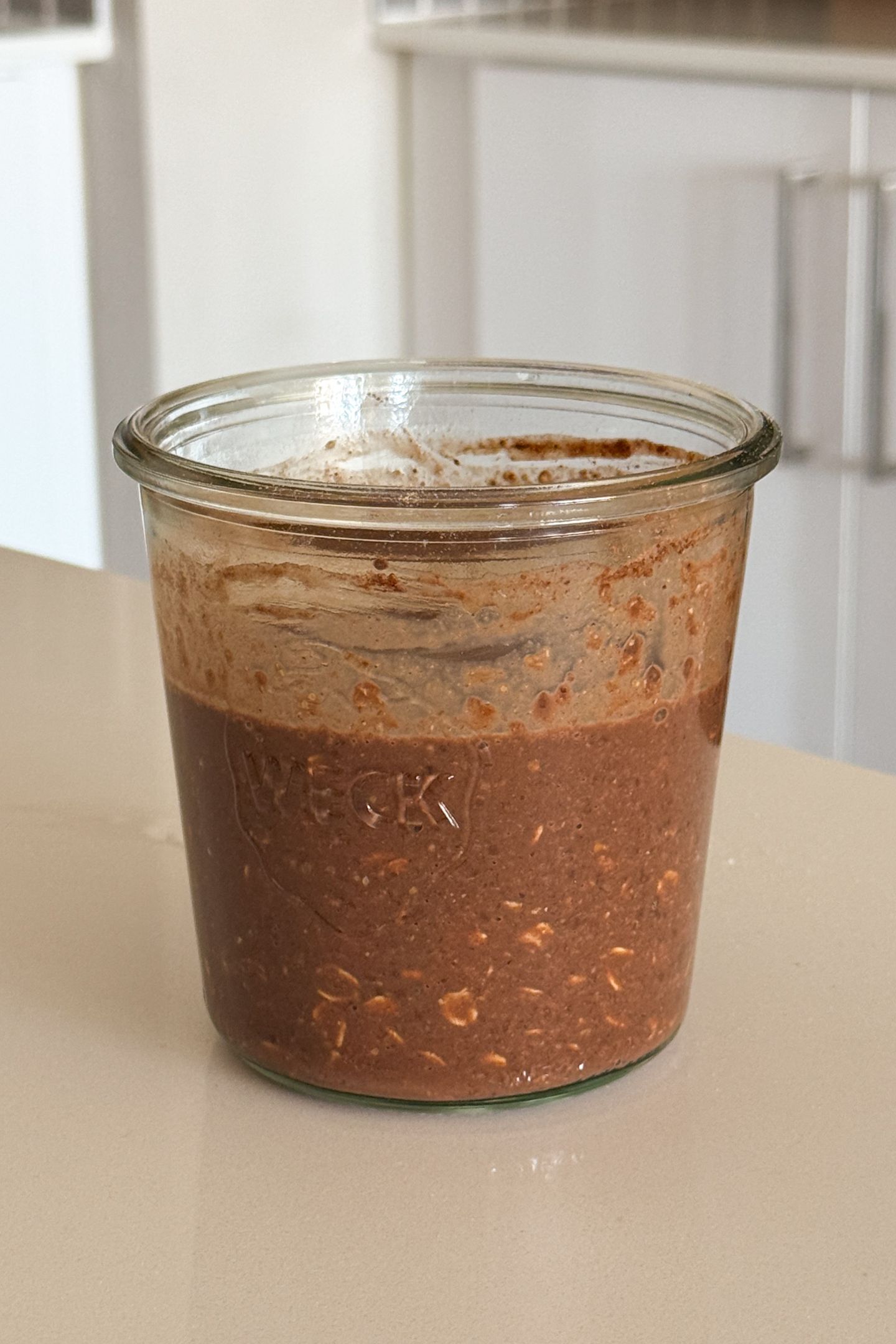 Chocolate banana overnight oats batter mixed together in mason jar.