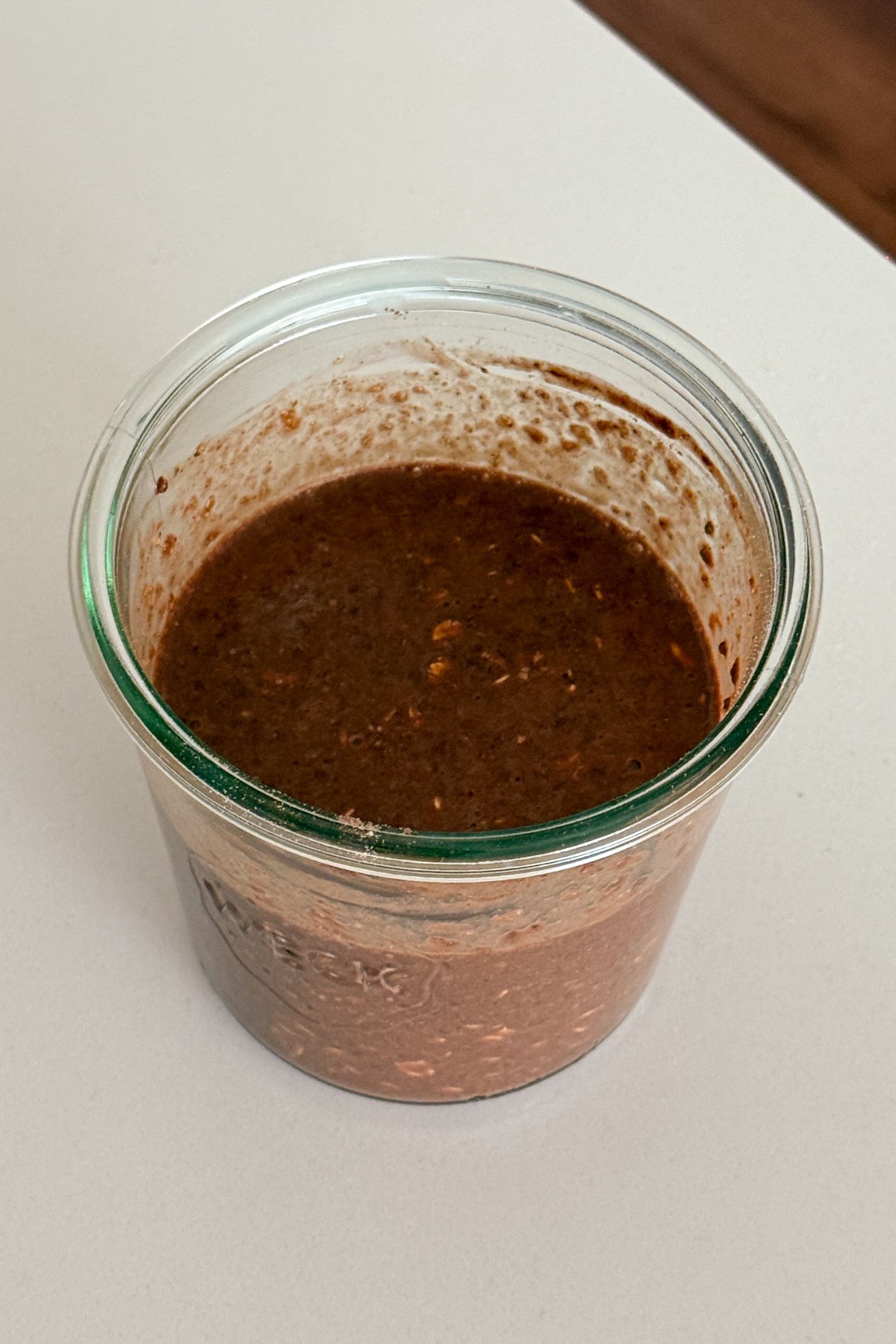 Chocolate banana overnight oats batter mixed together in mason jar.