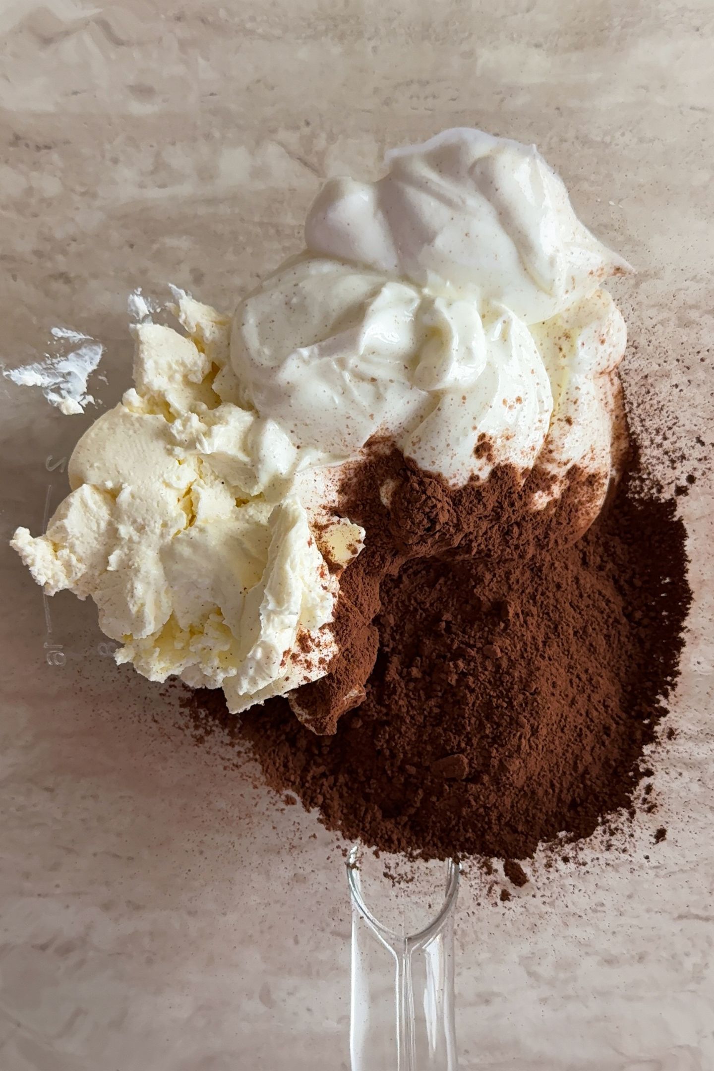 Cream Cheese, Cocoa Powder and Greek Yogurt in a mixing bowl.