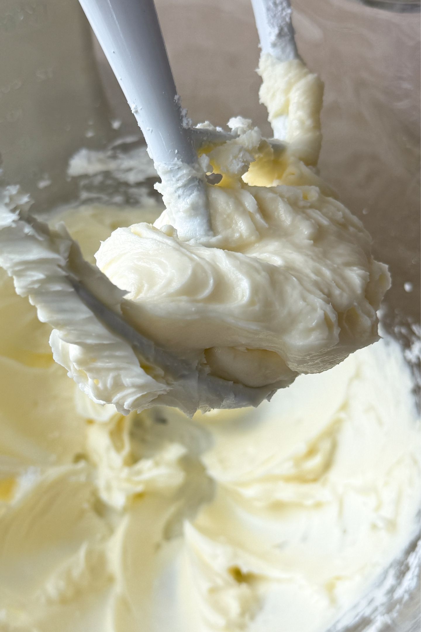 Softened butter and powdered sugar creamed together in a bowl.