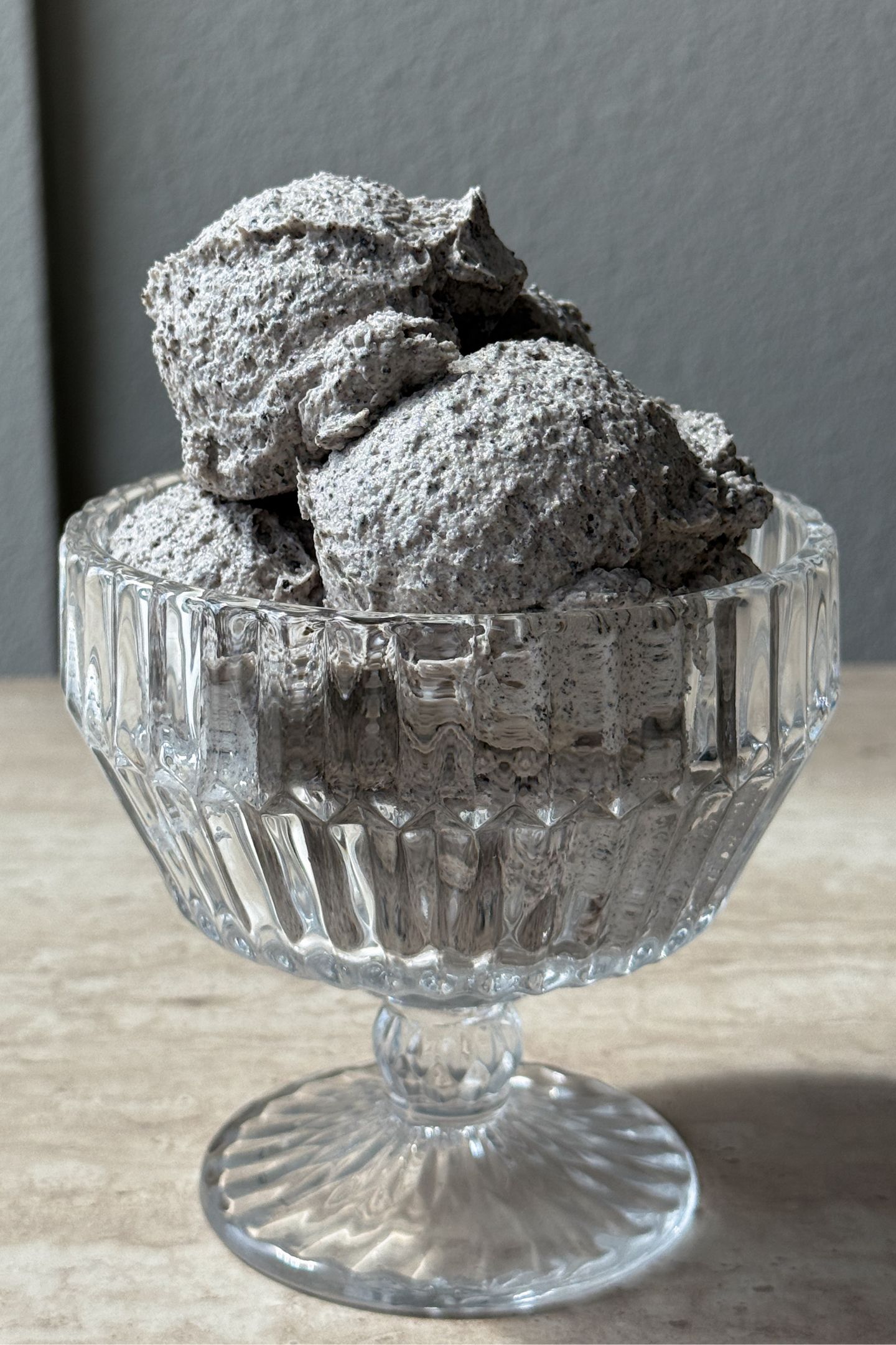 Scoops of oreo frosting in a glass bowl.