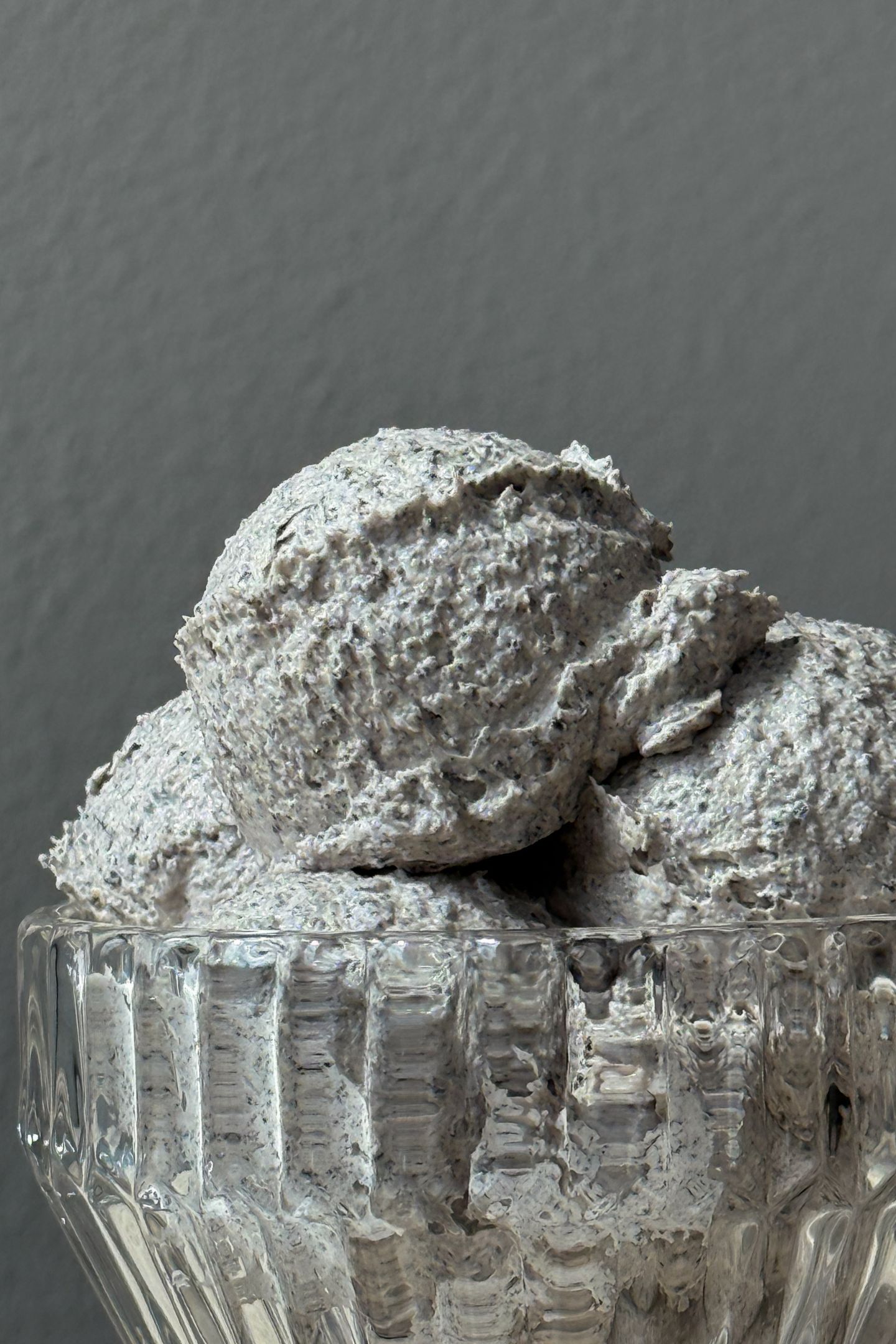 Oreo buttercream frosting scoops in a glass bowl.
