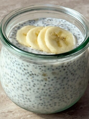 Banana Chia Pudding in a mason jar topped with banana slices.