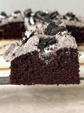 Slice of Chocolate Cookies and Cream Cake on a knife.