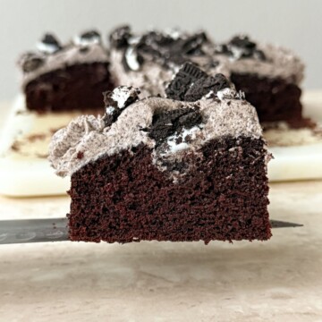 Slice of Chocolate Cookies and Cream Cake on a knife.