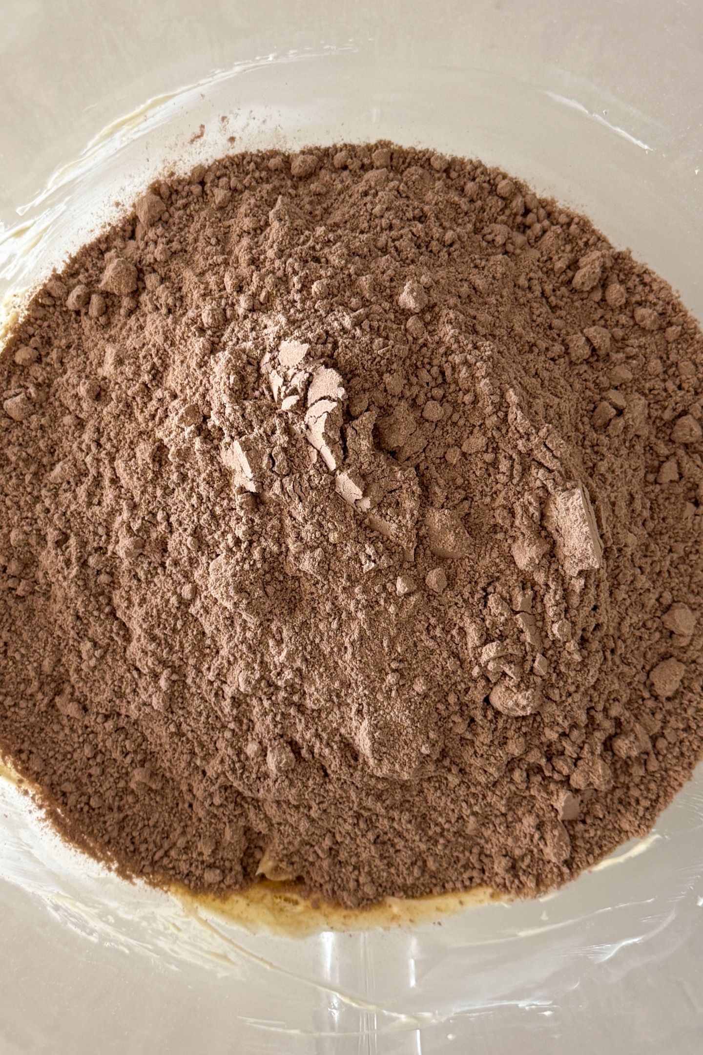 Adding the cake mix to the ingredients in the mixing bowl
