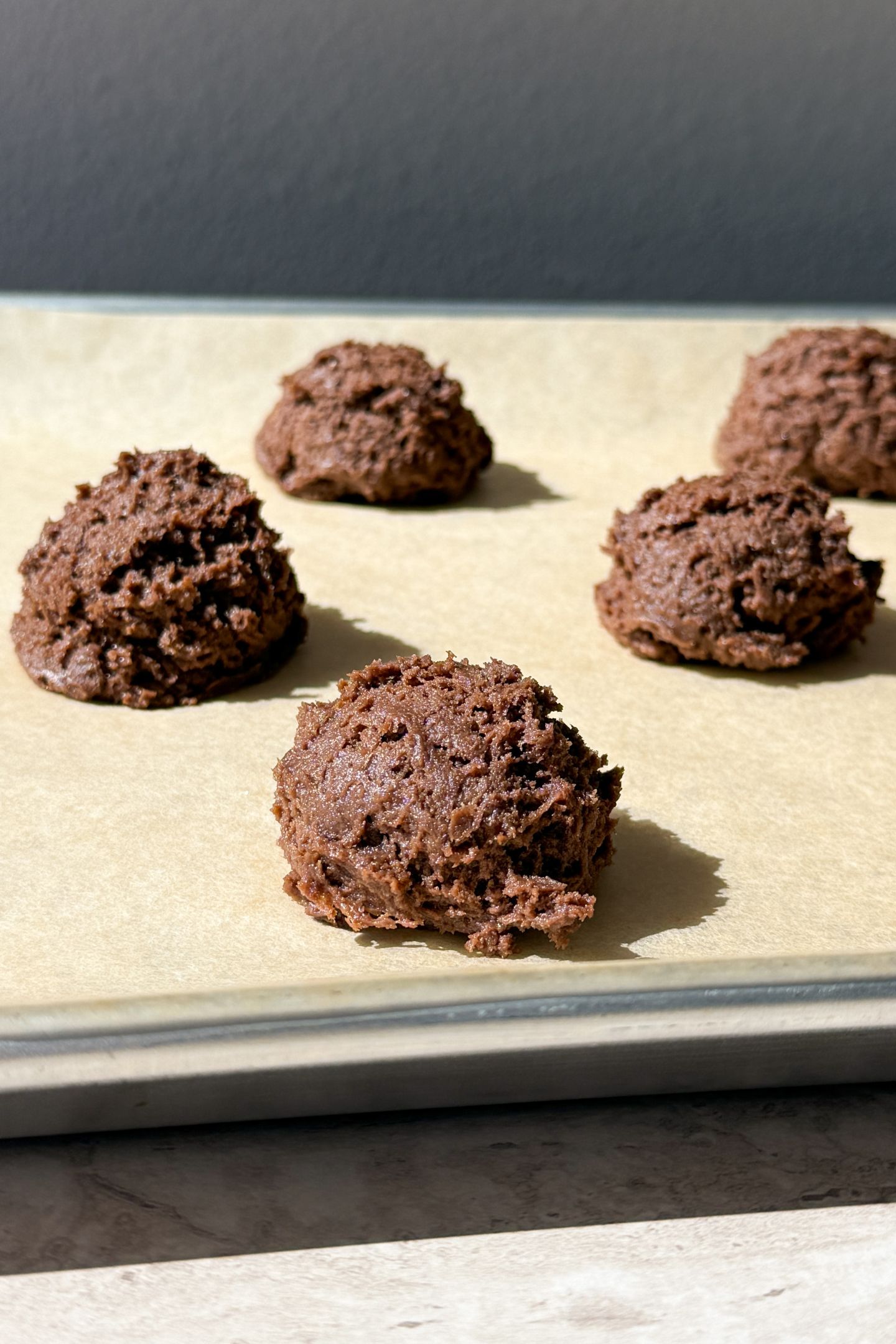 Scoop the dough onto the prepared baking sheet lined with parchment paper.