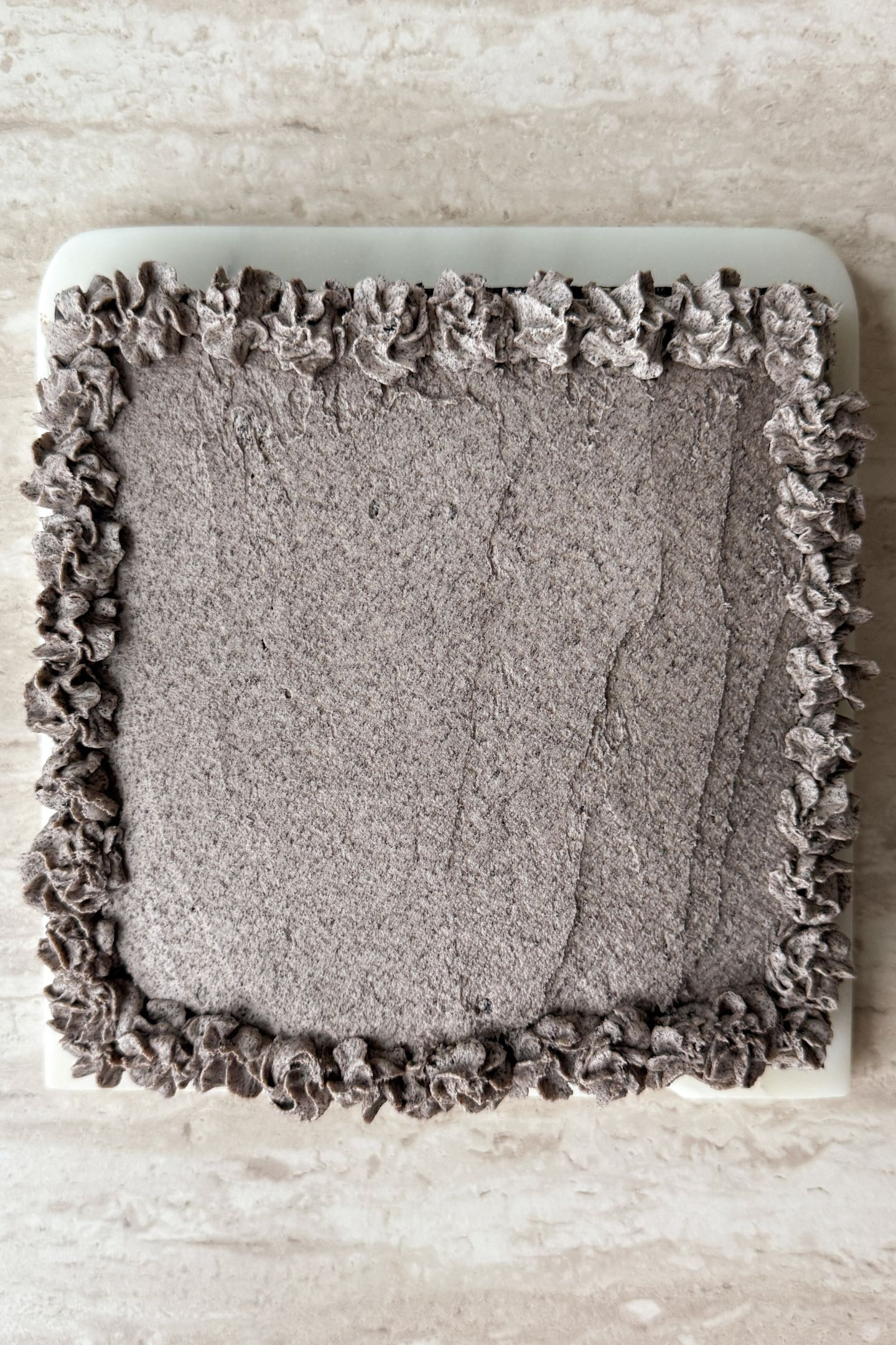 Decorating the cookies and cream frosting on top of the chocolate cake.
