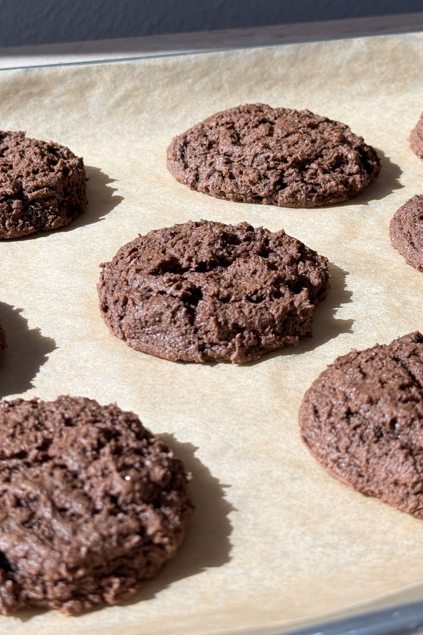 Baked cookies on a baking sheet lined with parchment paper.