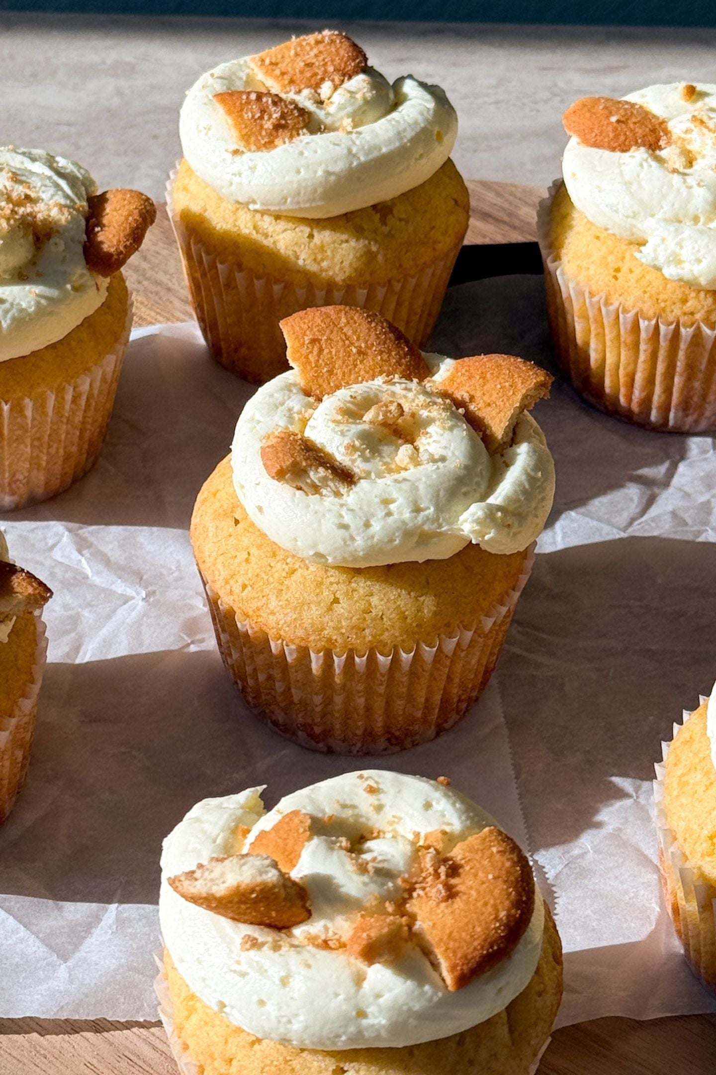 Banana Pudding Cupcakes topped with banana buttercream frosting and vanilla wafer cookies.