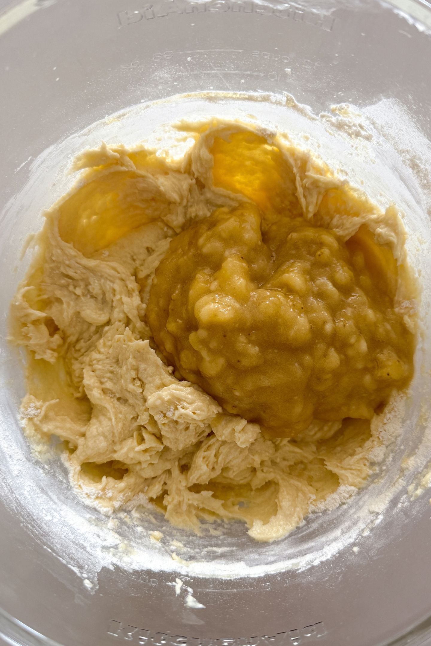 Adding mashed bananas to the banana chocolate chip cake batter.