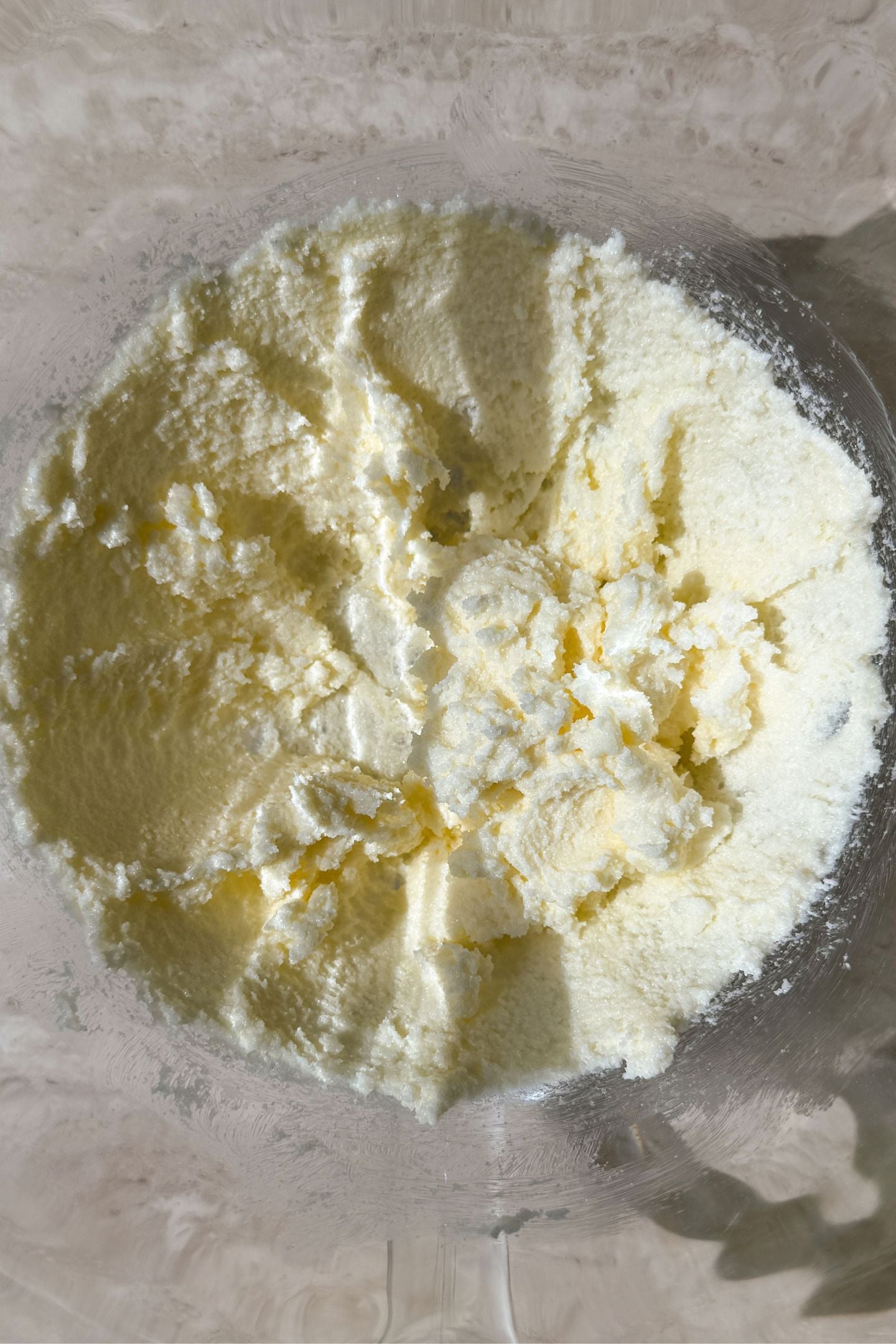 Butter and sugar creamed together in a mixing bowl.