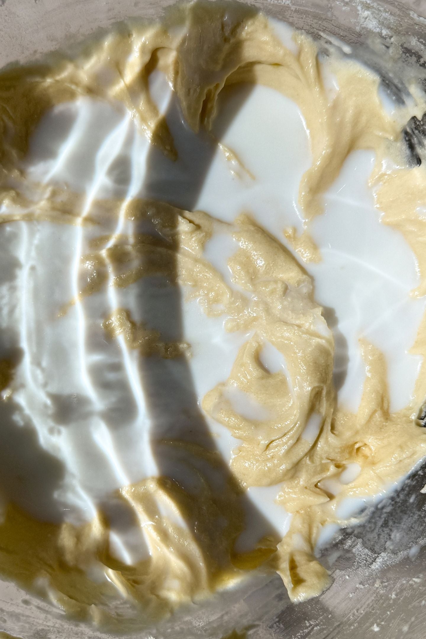 Adding half of the milk to the batter.