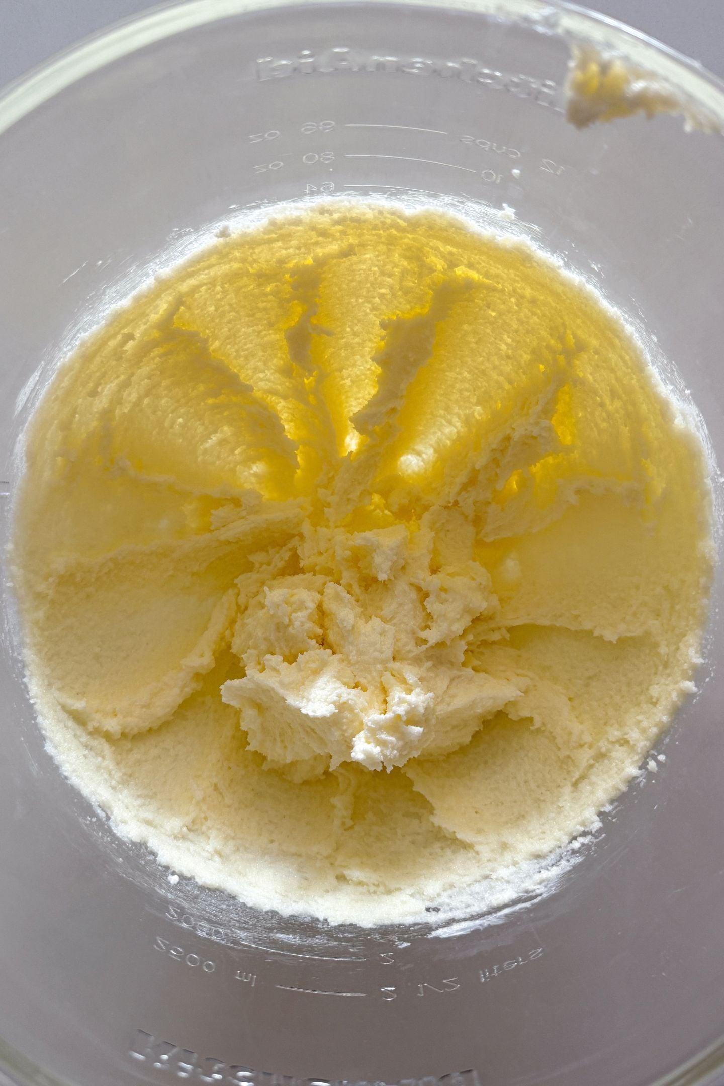 Butter and sugar creamed together in a stand mixer bowl.
