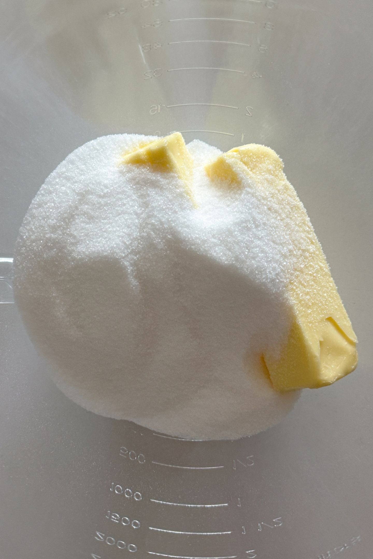 Butter and sugar in a stand mixer bowl.