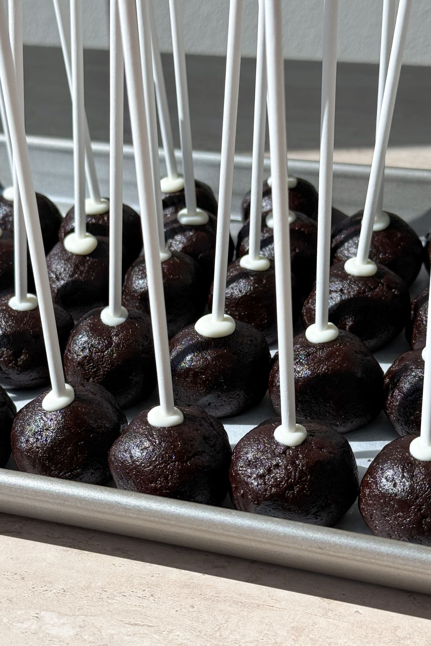 Sticks inserted to each cake pop.