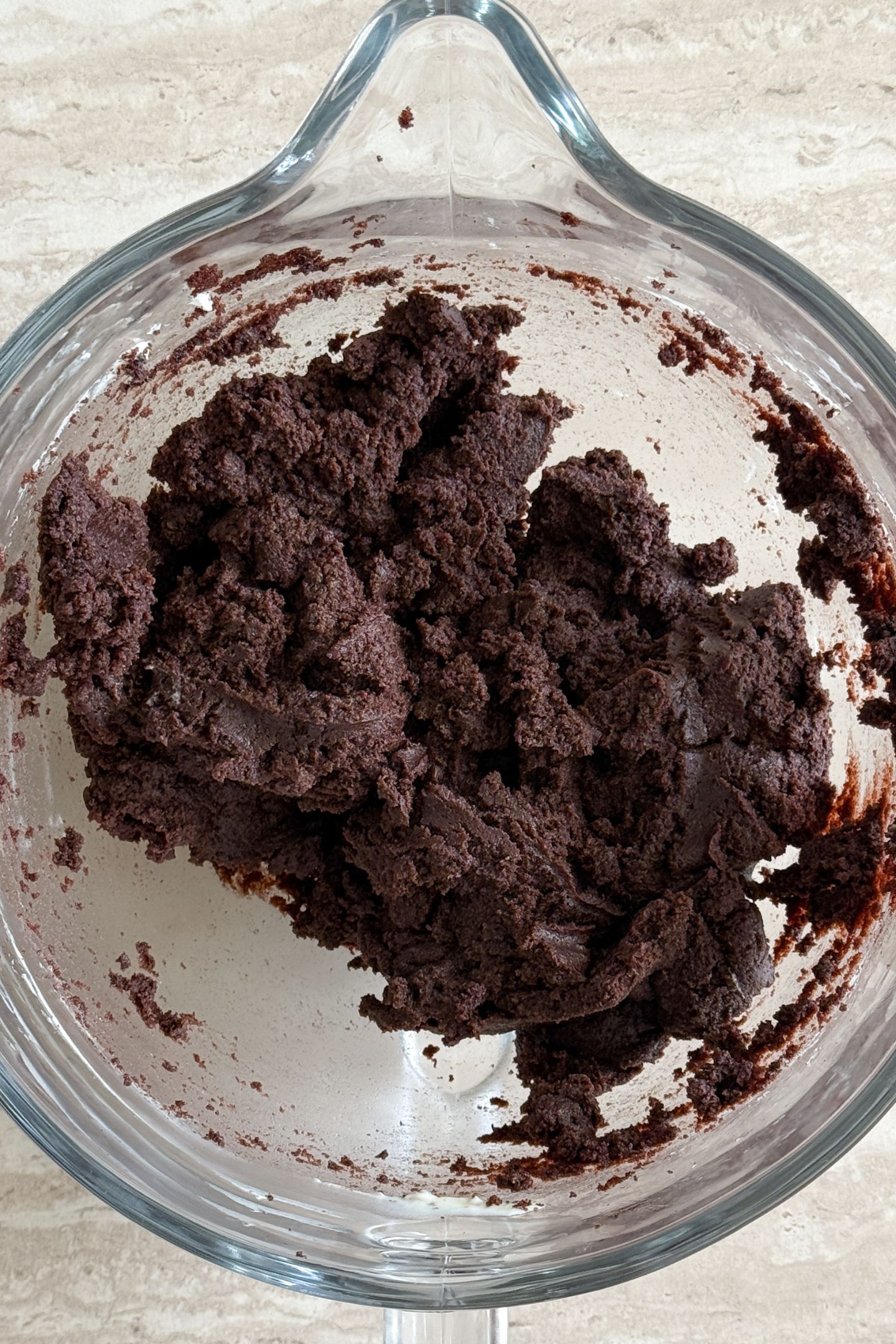 Cake and frosting mixed together in the mixing bowl.