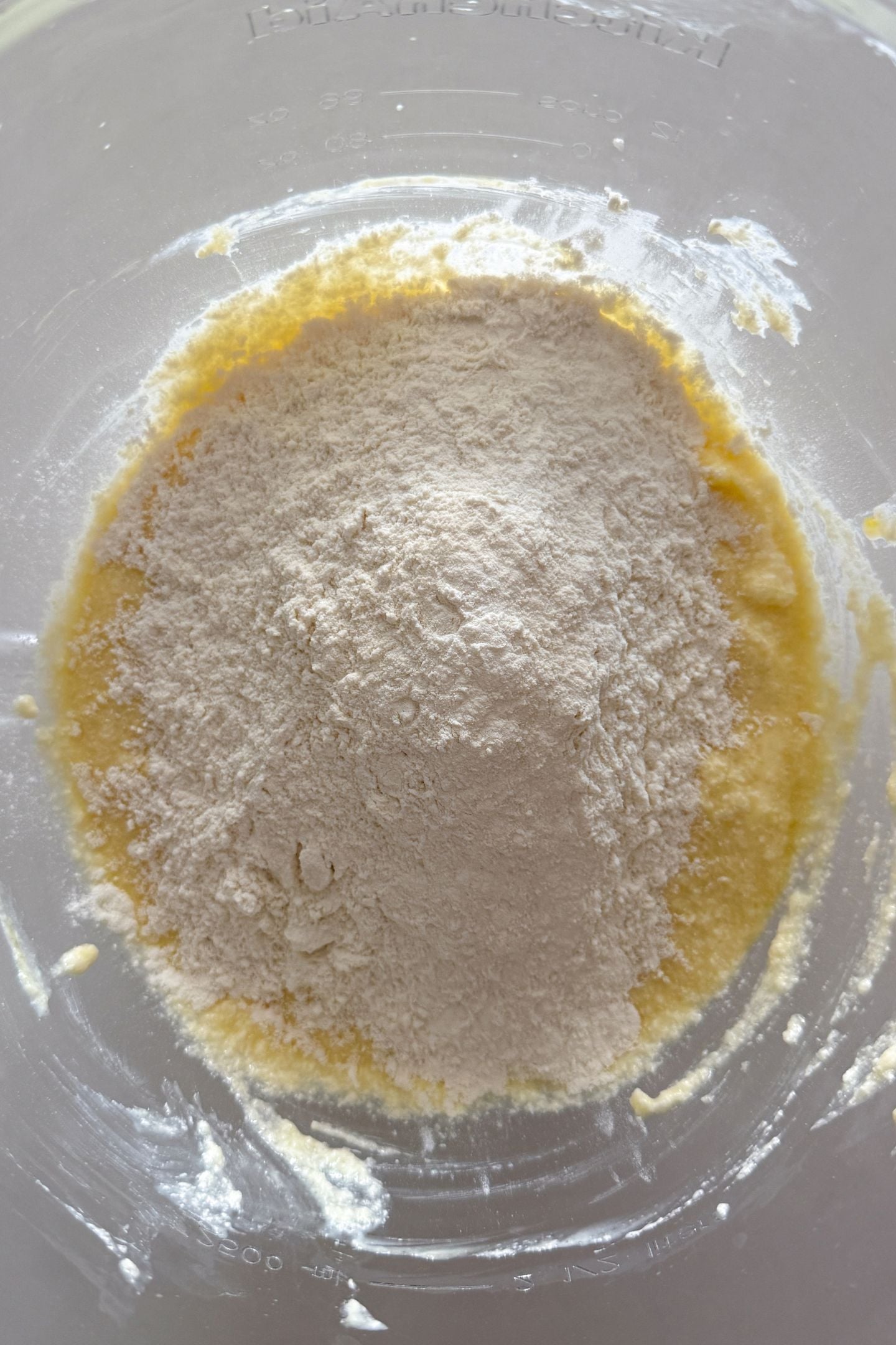Adding dry ingredients to the wet ingredients.