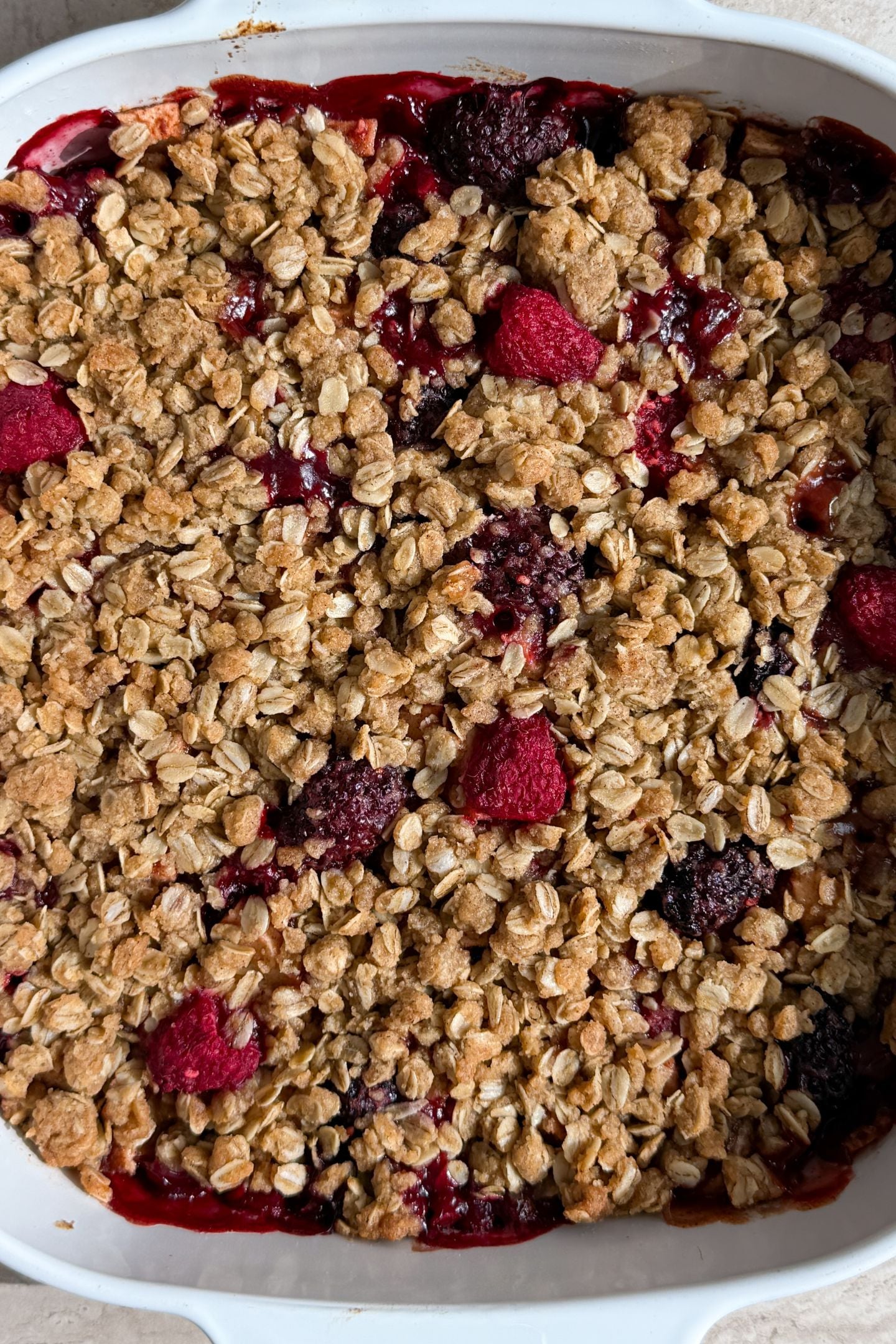 Baked apple and berry crisp in the baking pan.