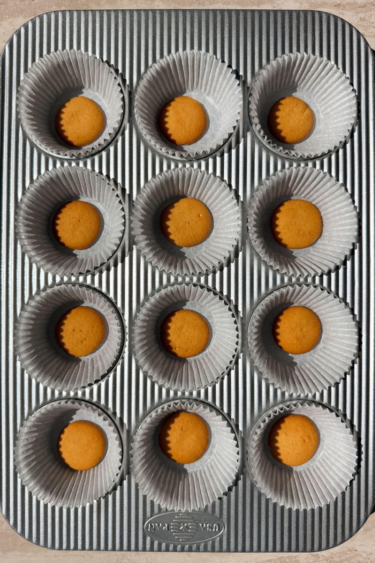 Vanilla wafer cookie added to the bottom of each cupcake liner.