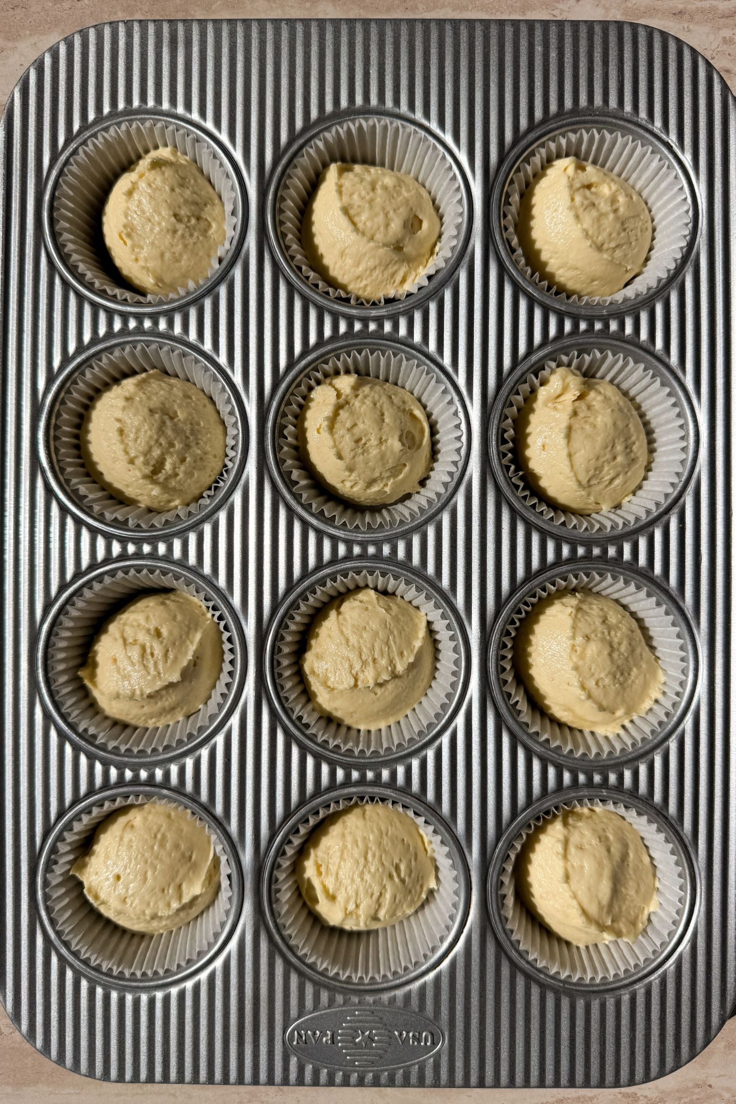 Cupcake batter added on top of the vanilla wafer cookie in the cupcake liners.