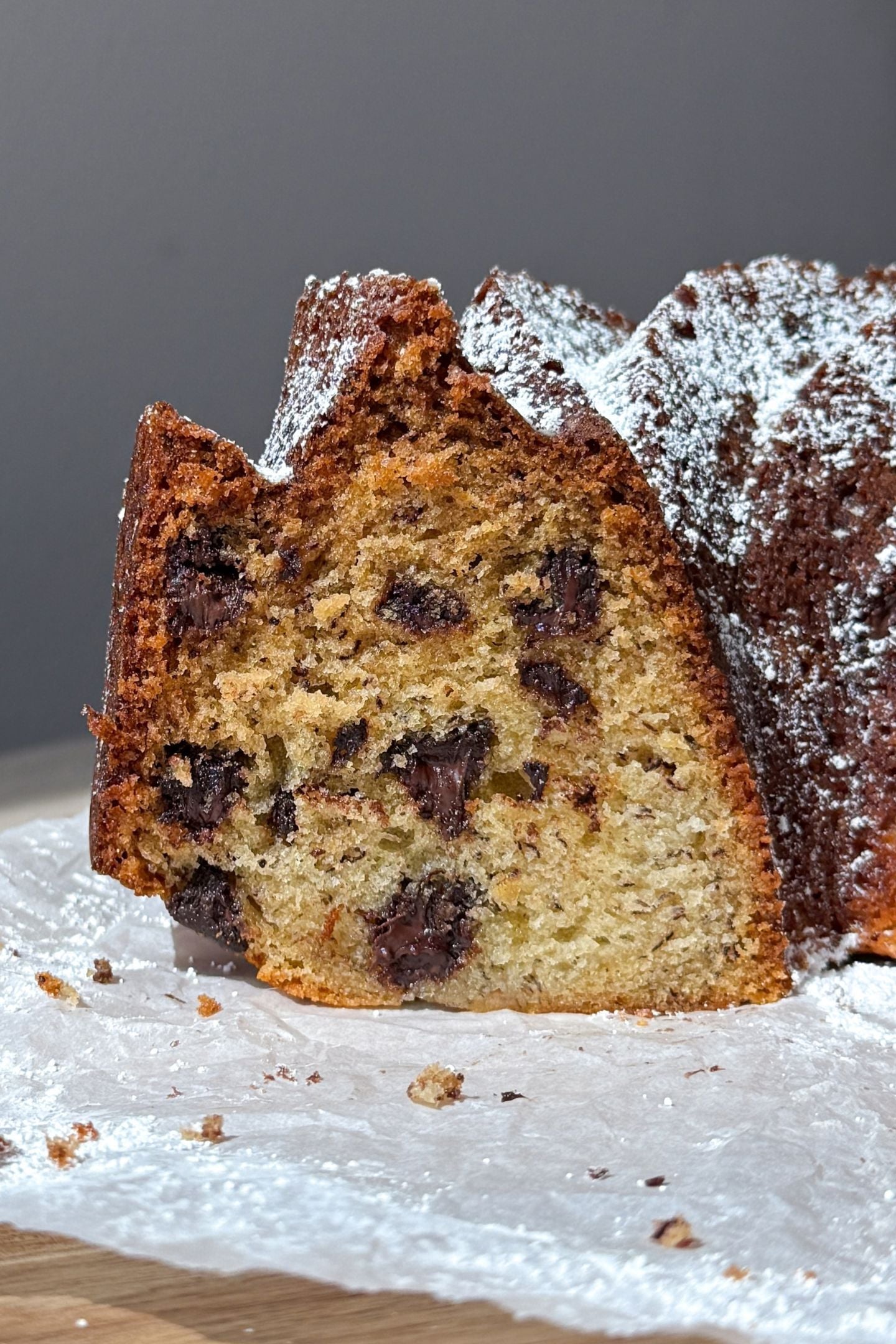 Side view of the Chocolate Chip Banana Bundt Cake topped with powdered sugar.
