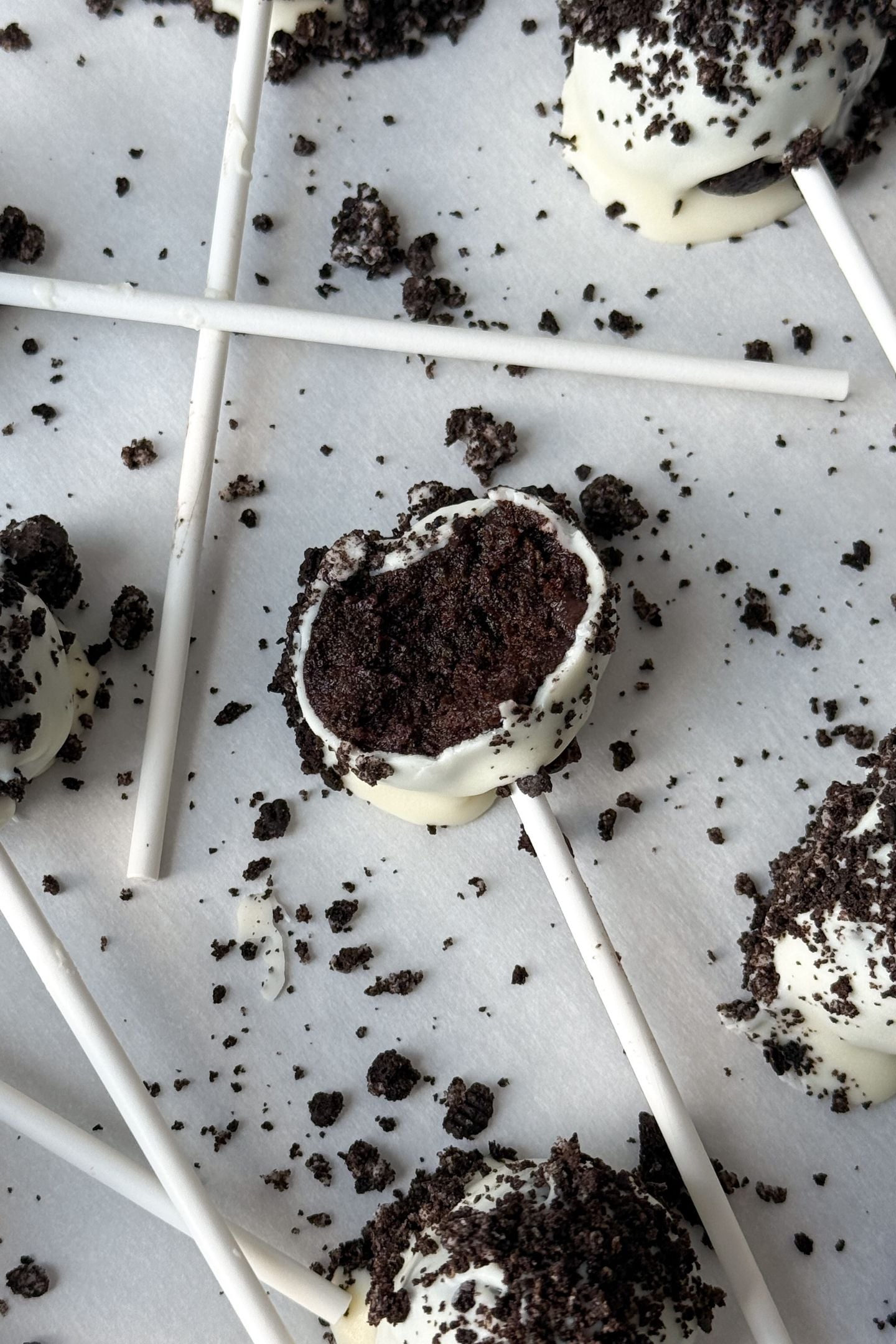 Oreo Cake Pop with a bite taken out of it.
